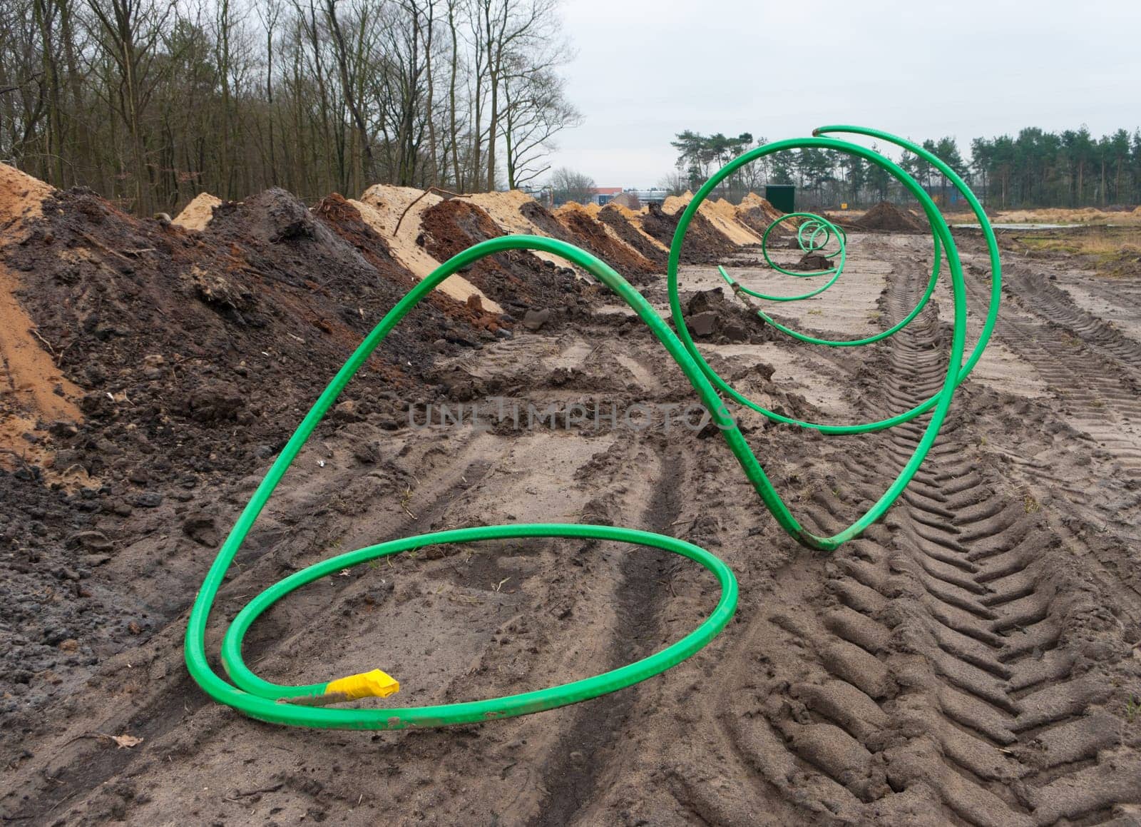 green fiber cable ready to go into the ground on a newly build industrial area