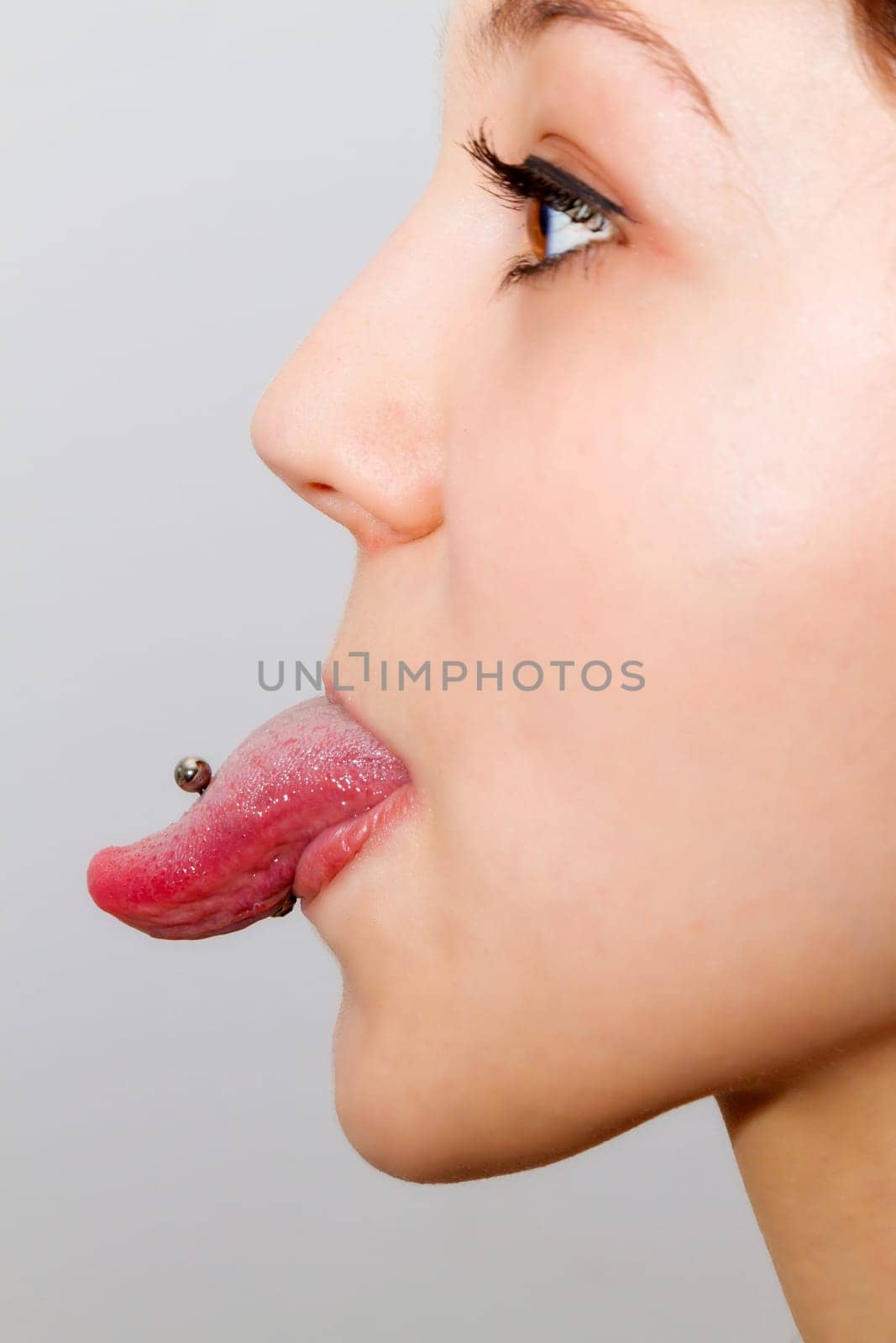 Tongue piercing in profile