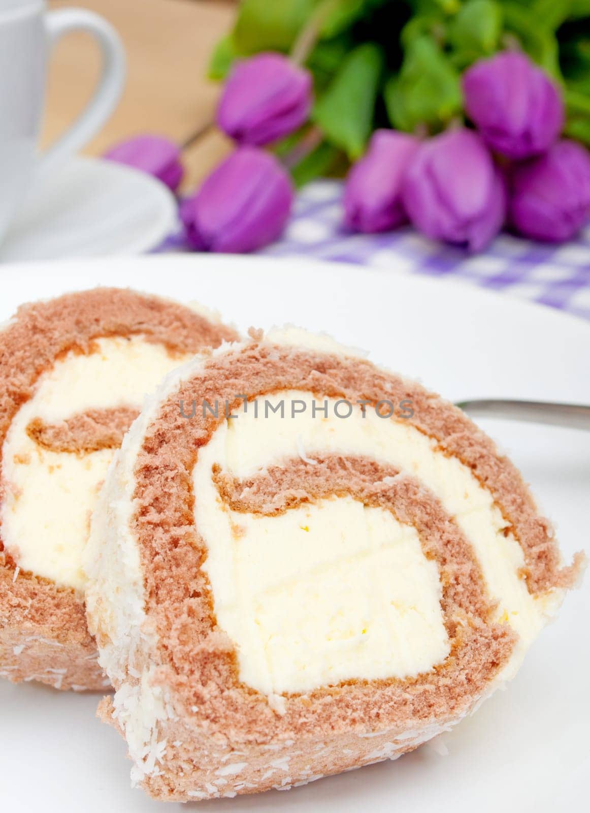 Swiss Sponge Roll With Cream on White Plate - Shallow Depth of Field