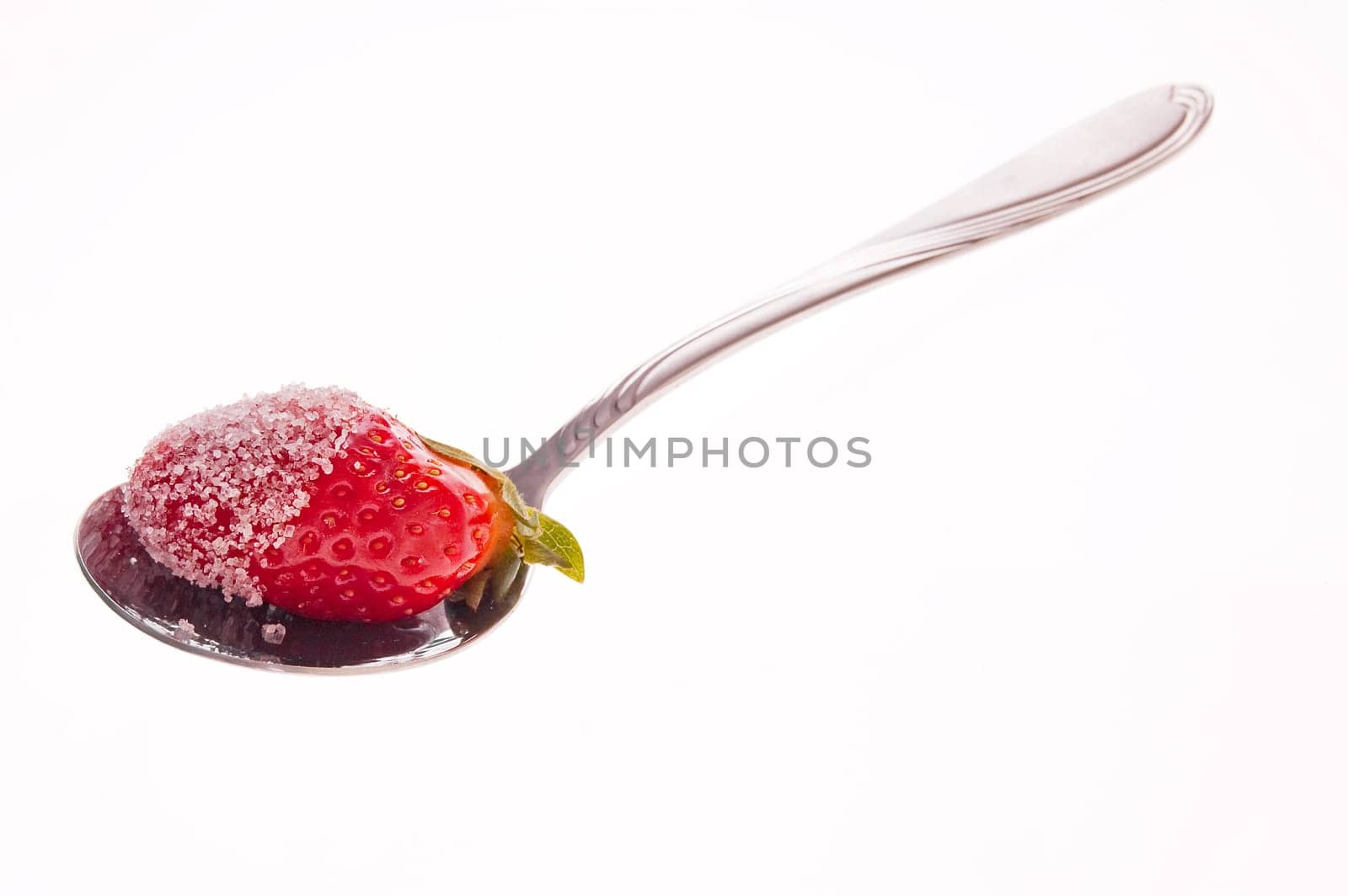 Strawberry in sugar served on a spoon