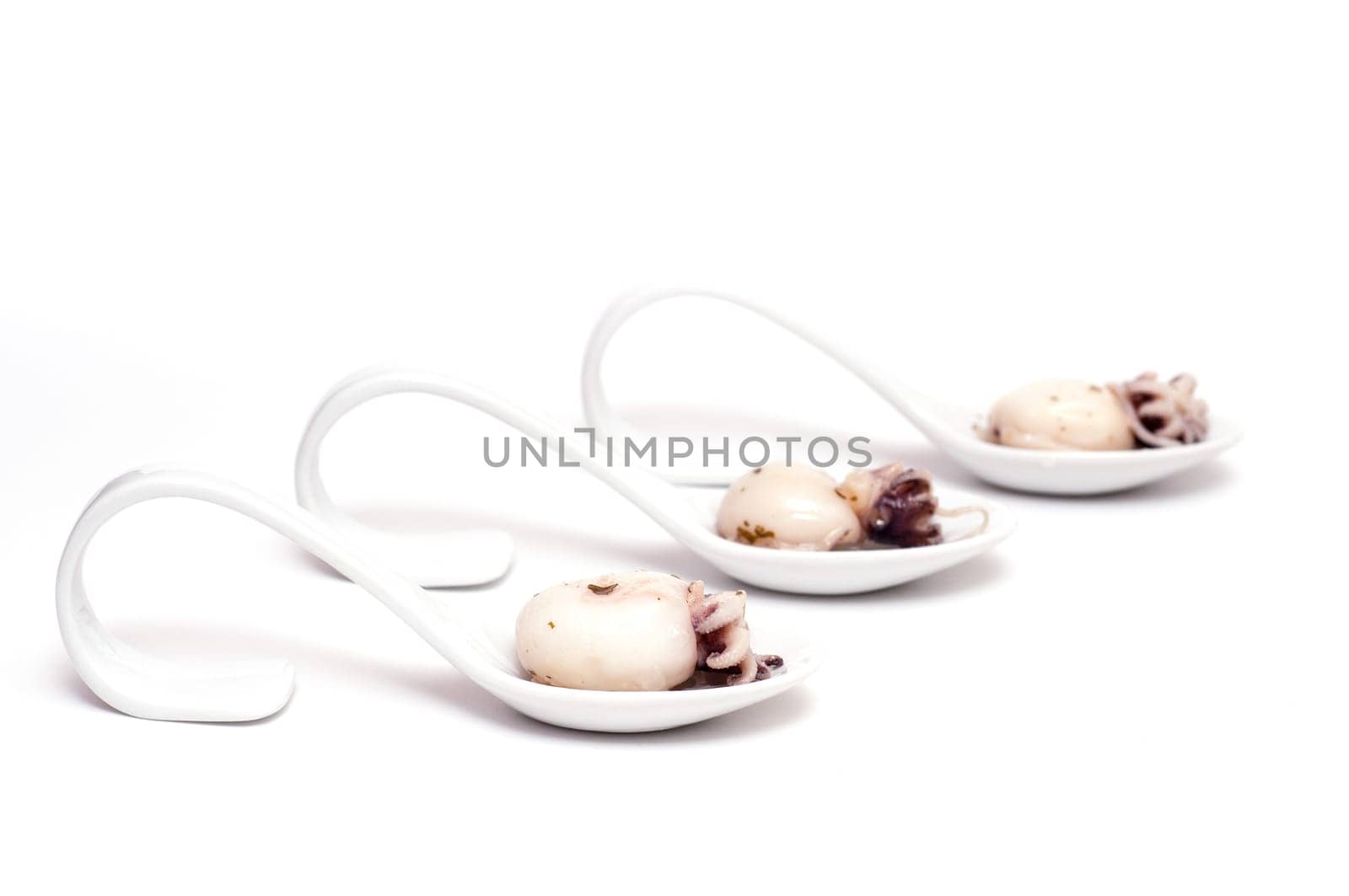 Three spoons of porcelain with cuttlefish squid