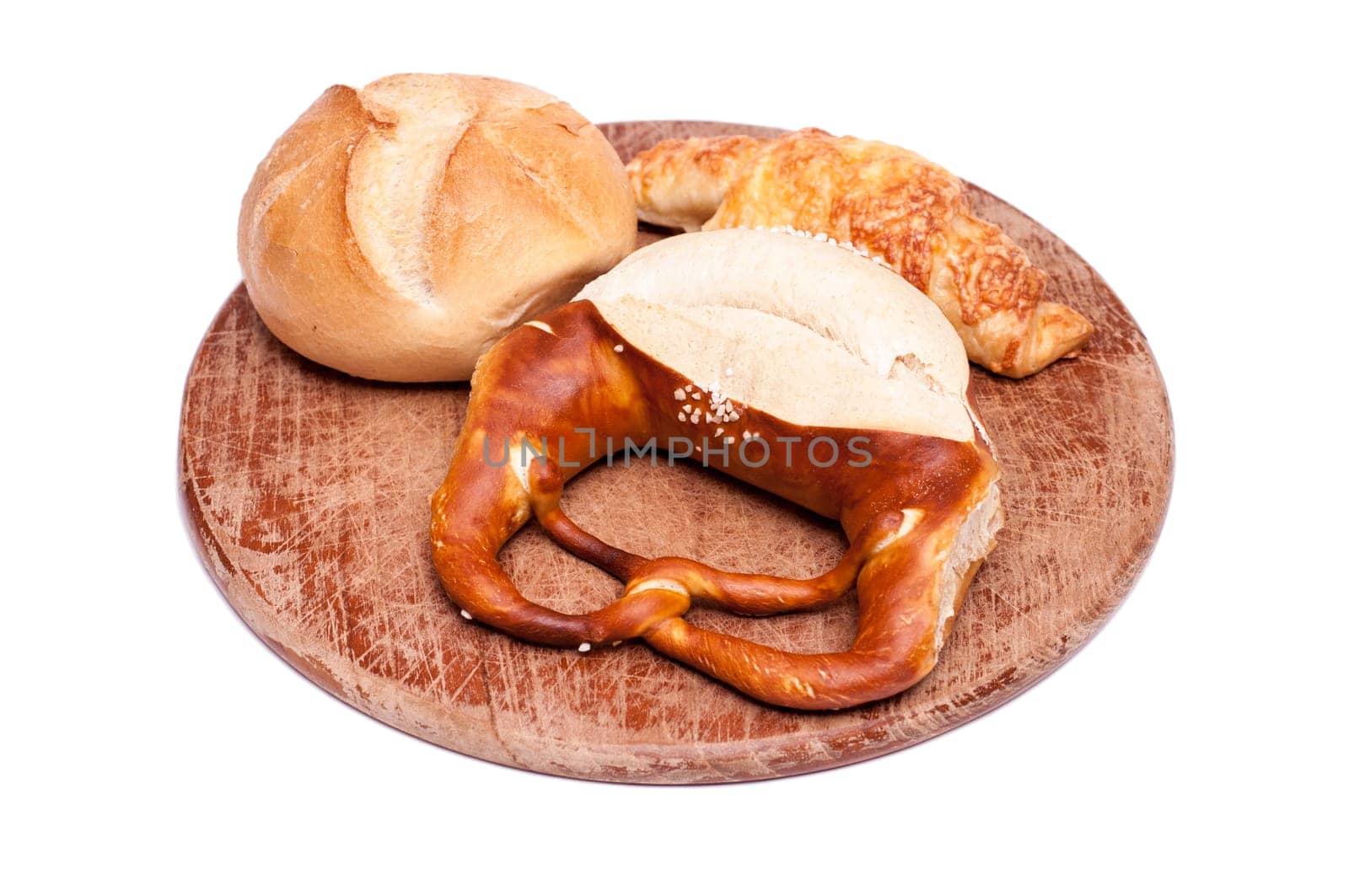 Pretzel,rolls and ham croissants on a snack board