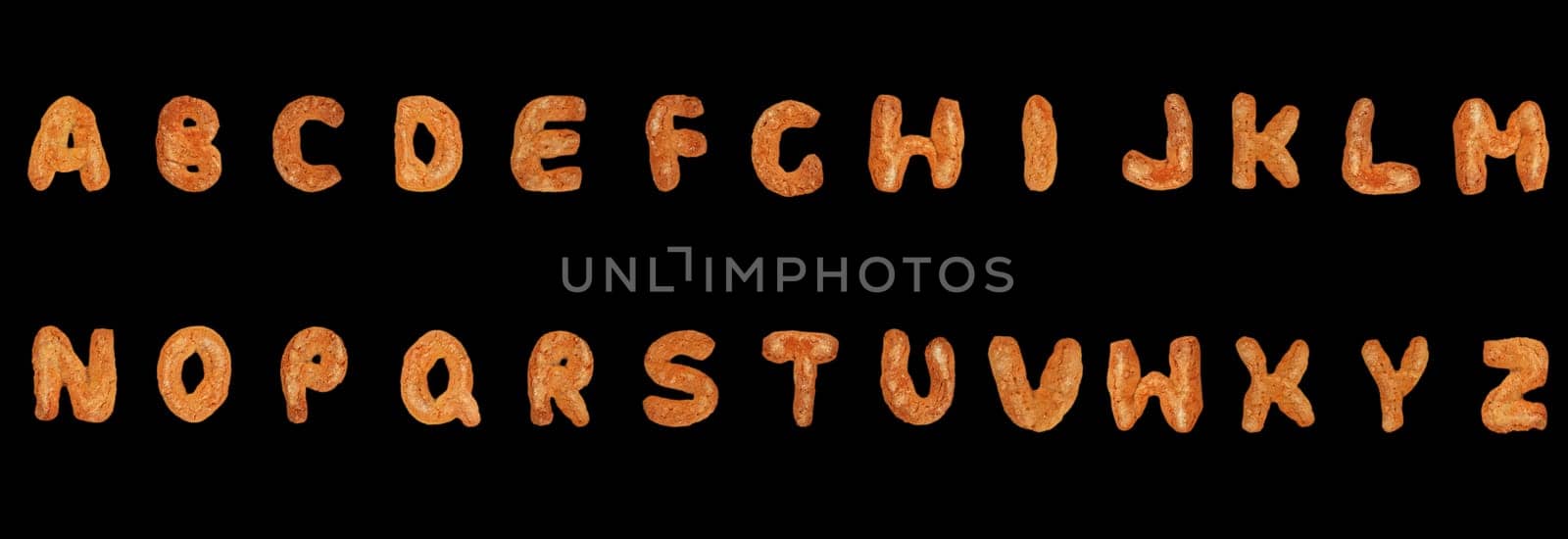 Letters of the British alphabet made of gingerbread over black background