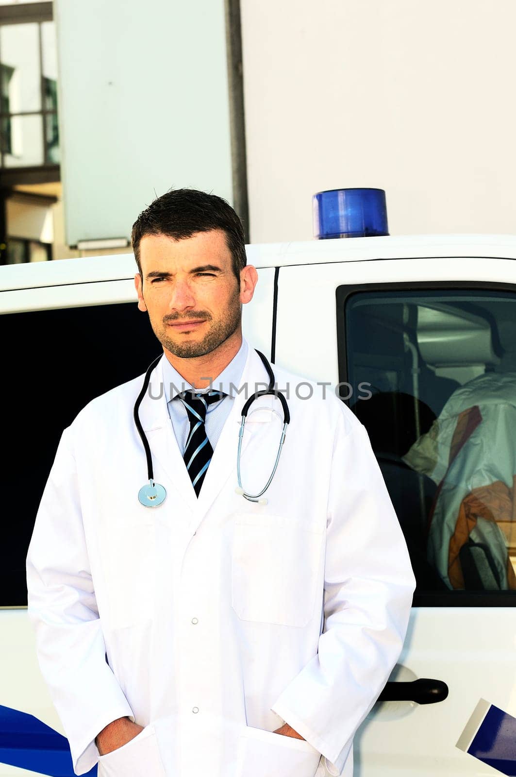 doctor is writing a report behind an ambulance