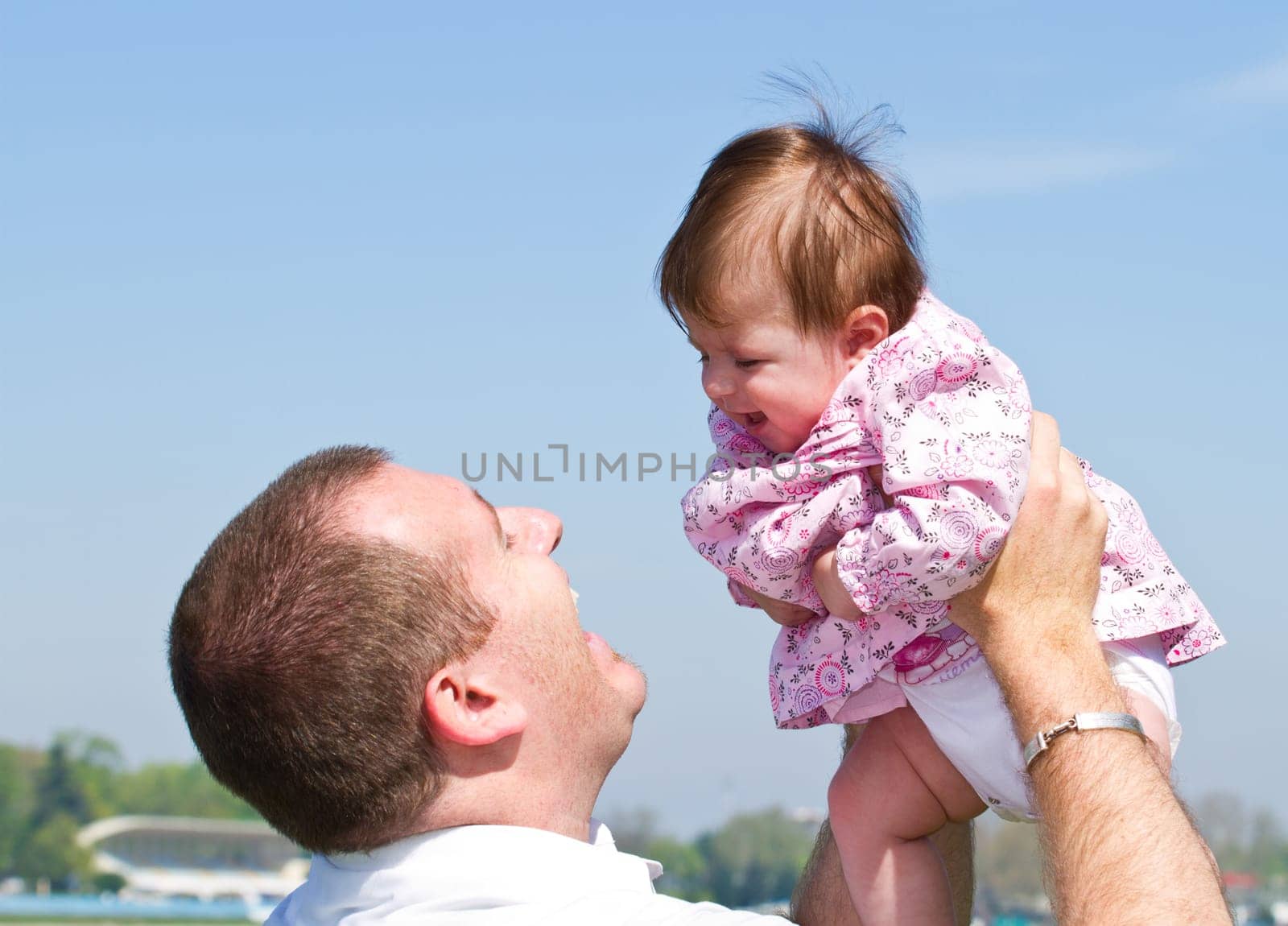 father playing with his baby