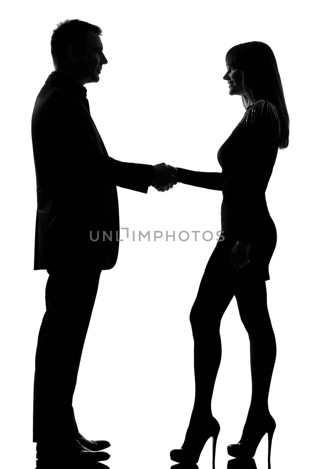 one caucasian couple man and woman handshake in studio silhouette isolated on white background