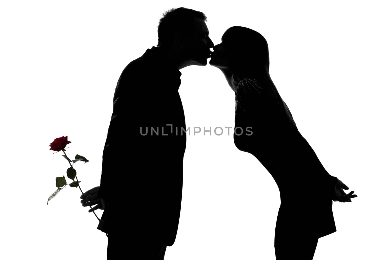 one caucasian couple man and woman kissing in studio silhouette isolated on white background