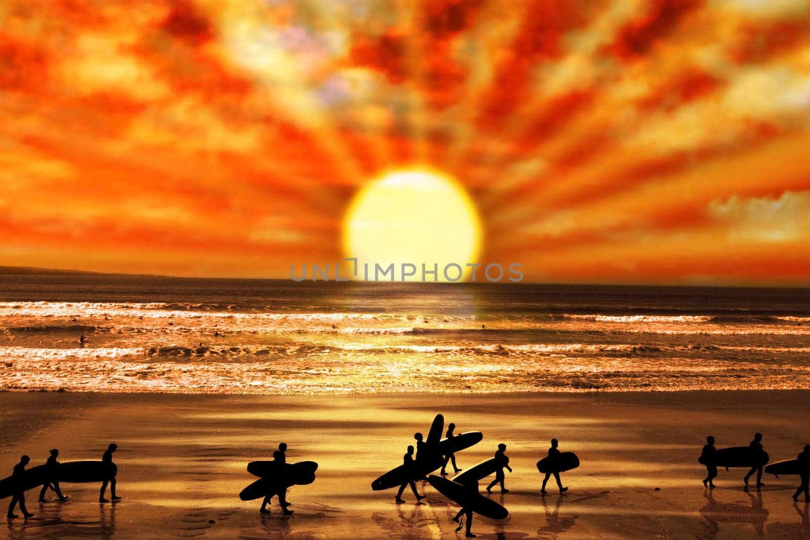 surfers walking on the beach in lahinch county clare ireland as the sun goes down