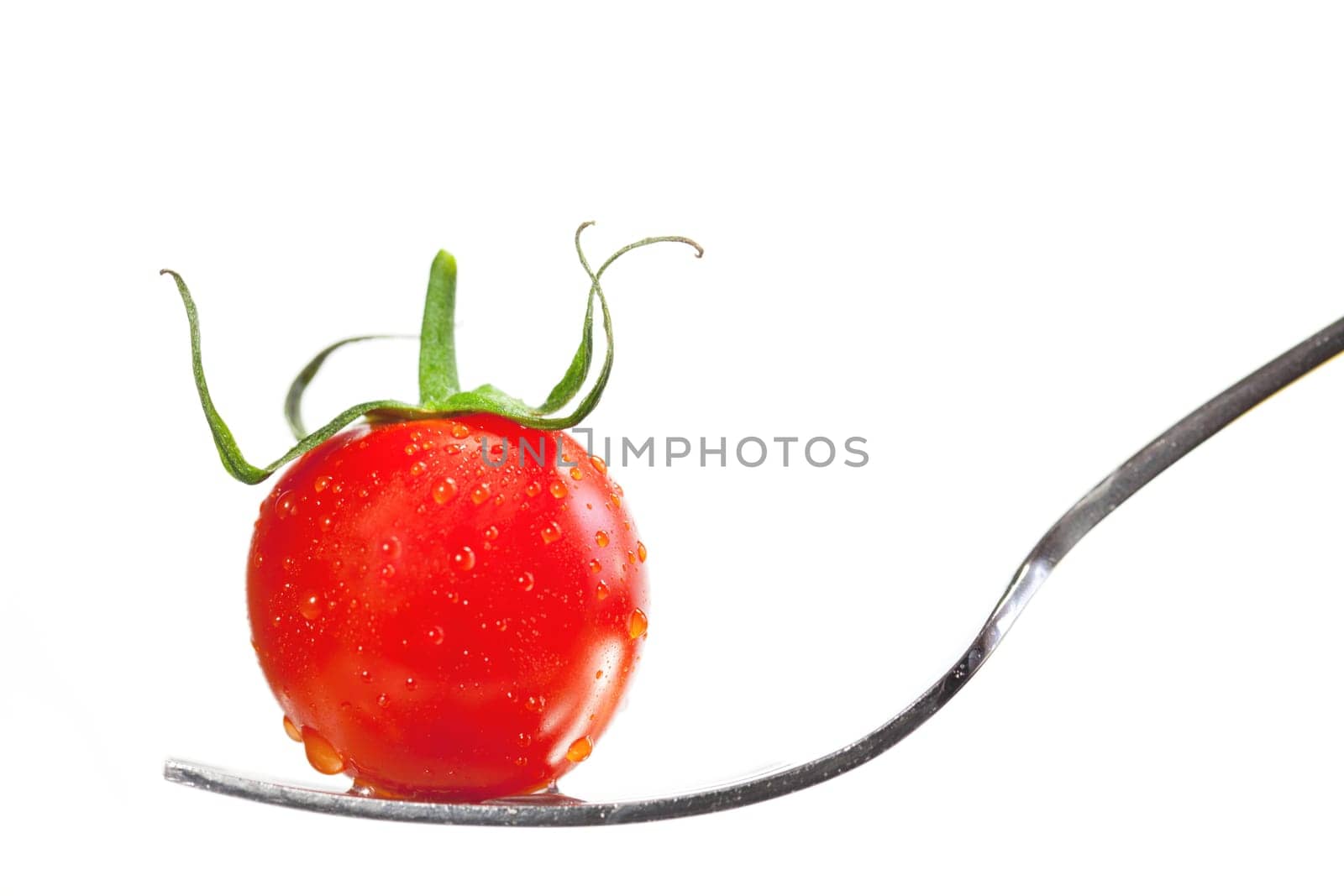 Tomato on a fork isolated on white