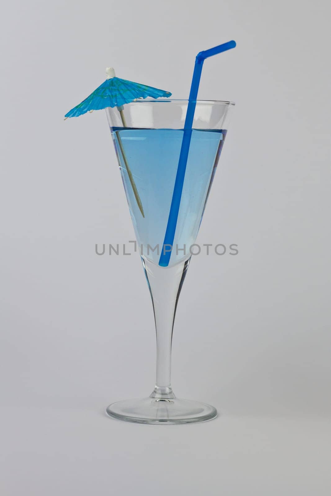 Single Blue Martini with matching straw and umbrella