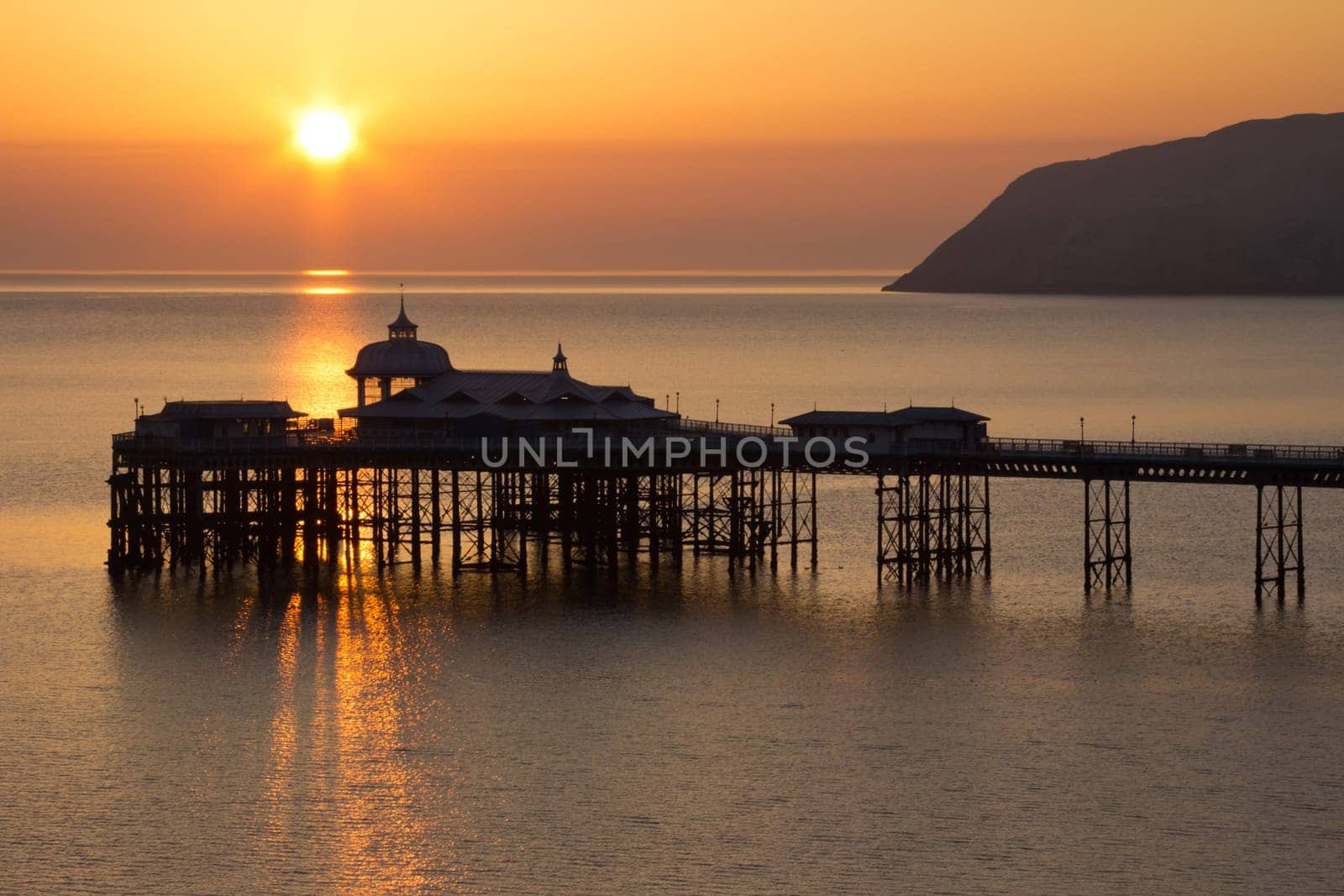 Golden Sunrise over the historic pier in Llandudno Wales