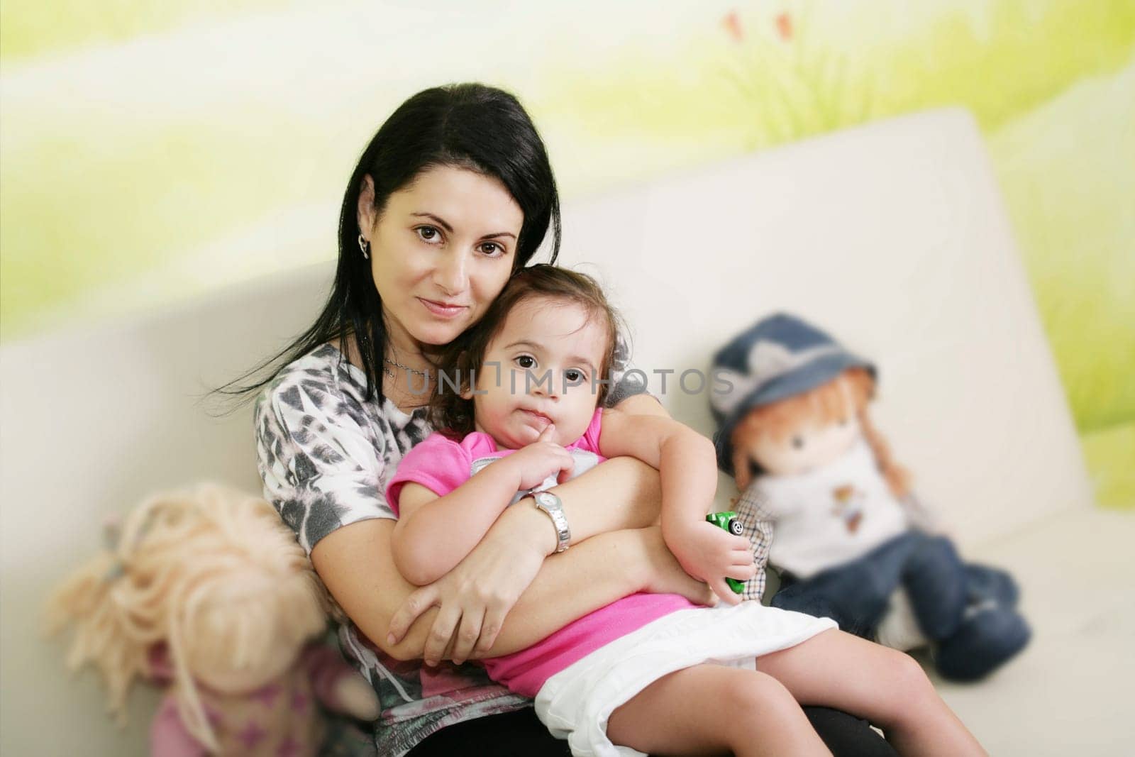 Mother and daughter in the waiting room at doctors office.