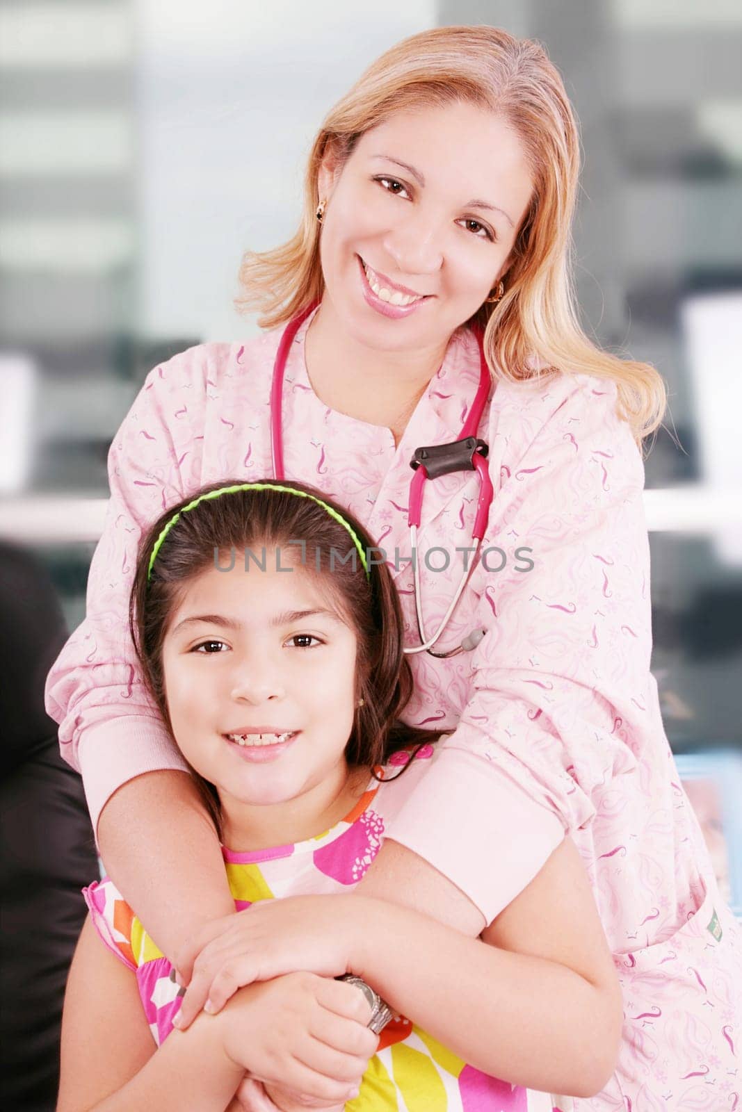 Little cheerful girl visiting the doctor