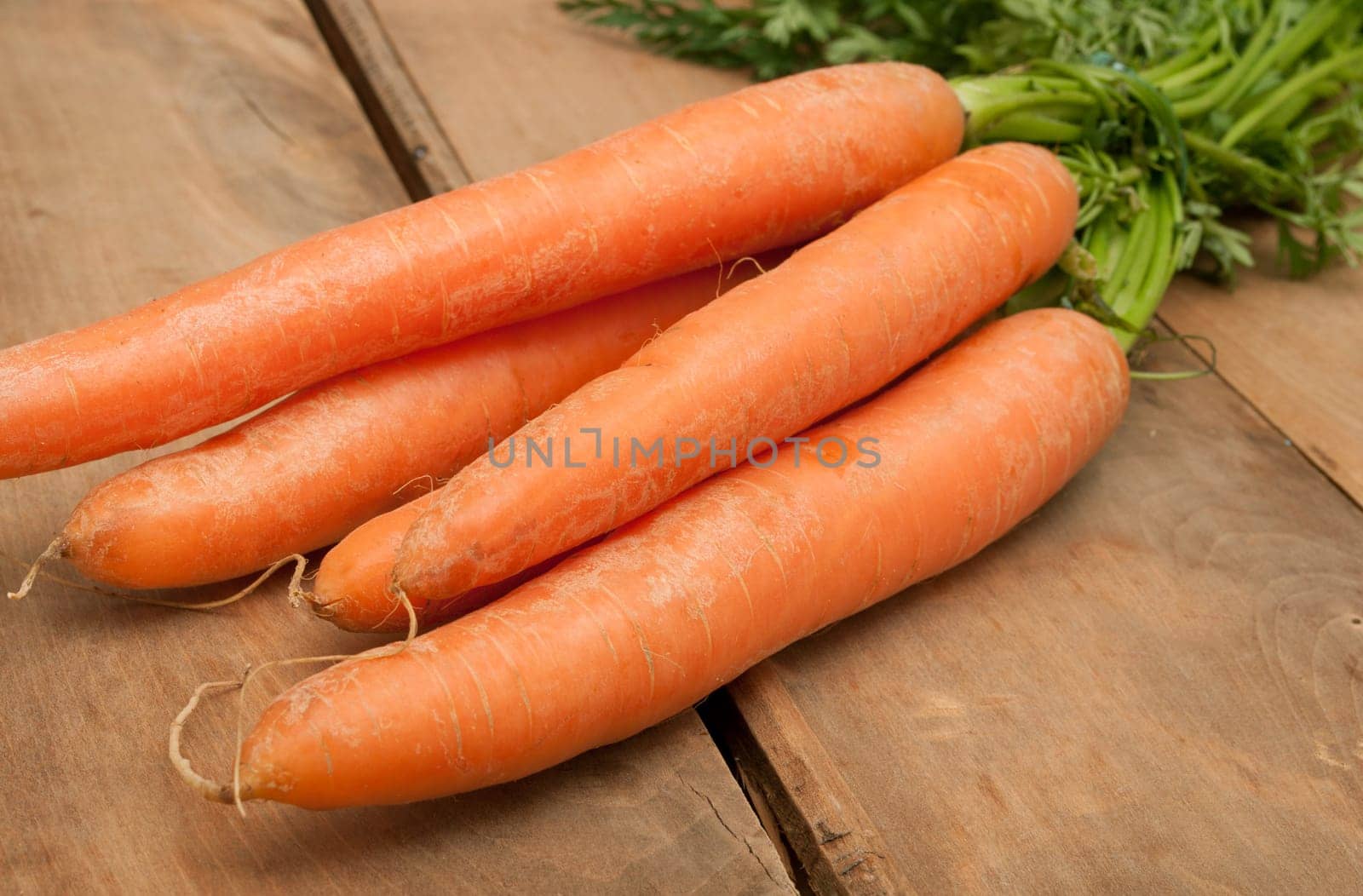 Bunch of Raw Carrots on Aged Wooden Table