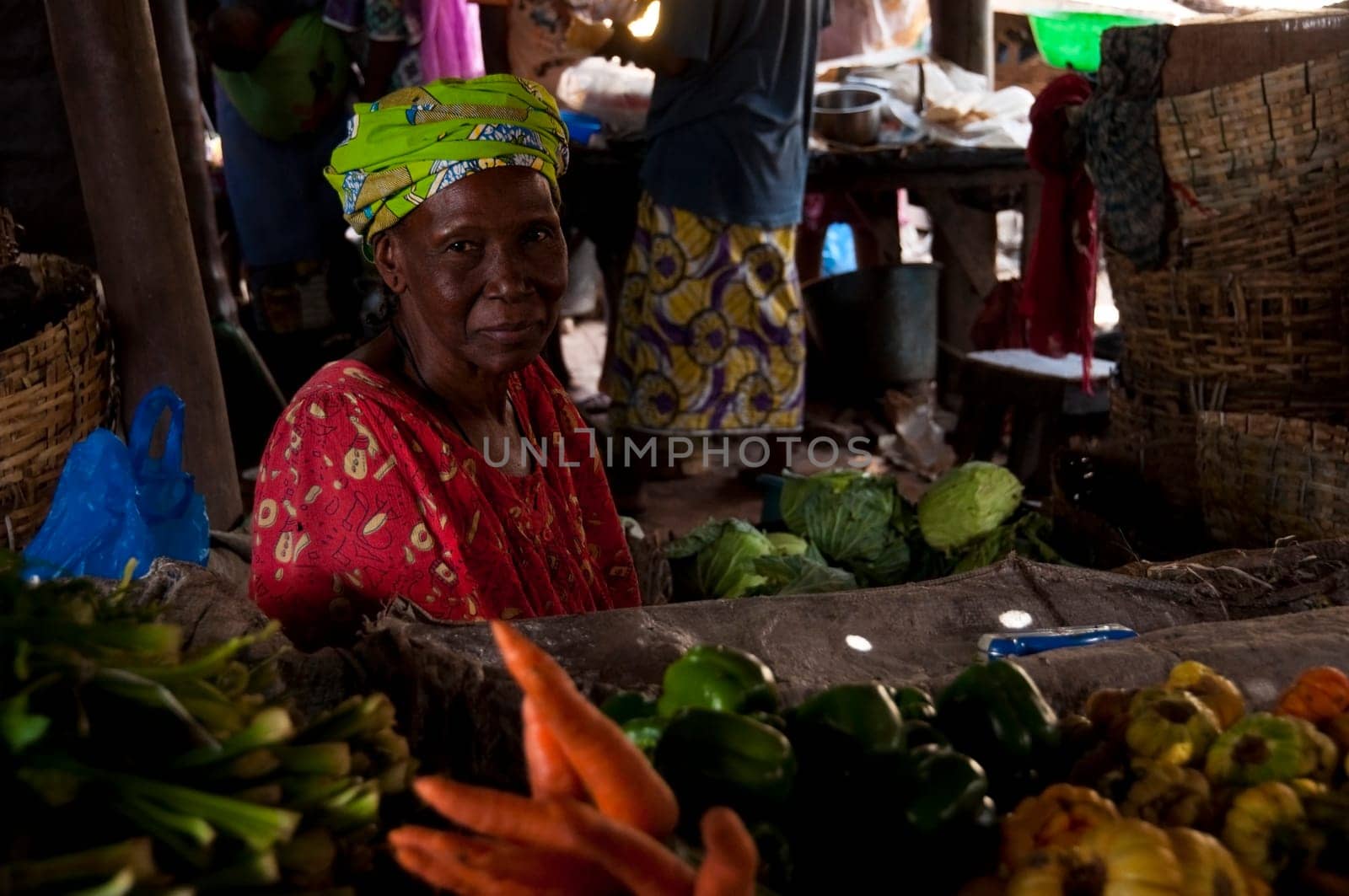 Shopkeeper selling vegetables at the local market in Bamako, Mali