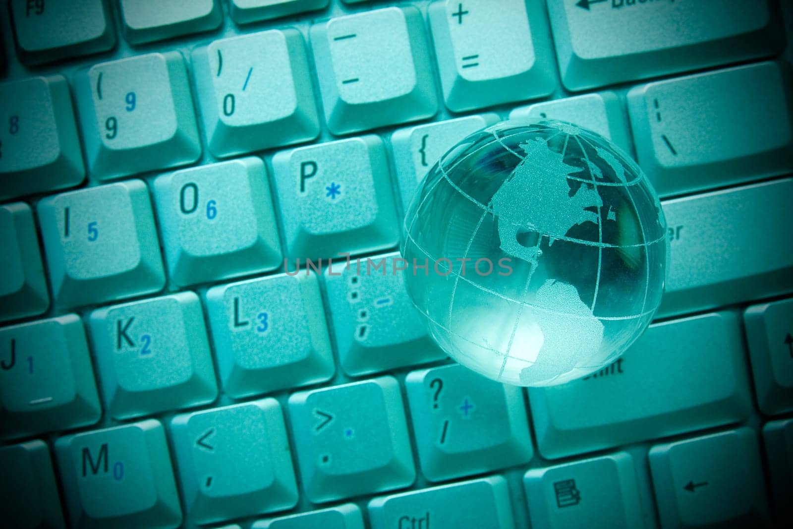 internet concept. Crystal-glass globe on keyboard of notebook