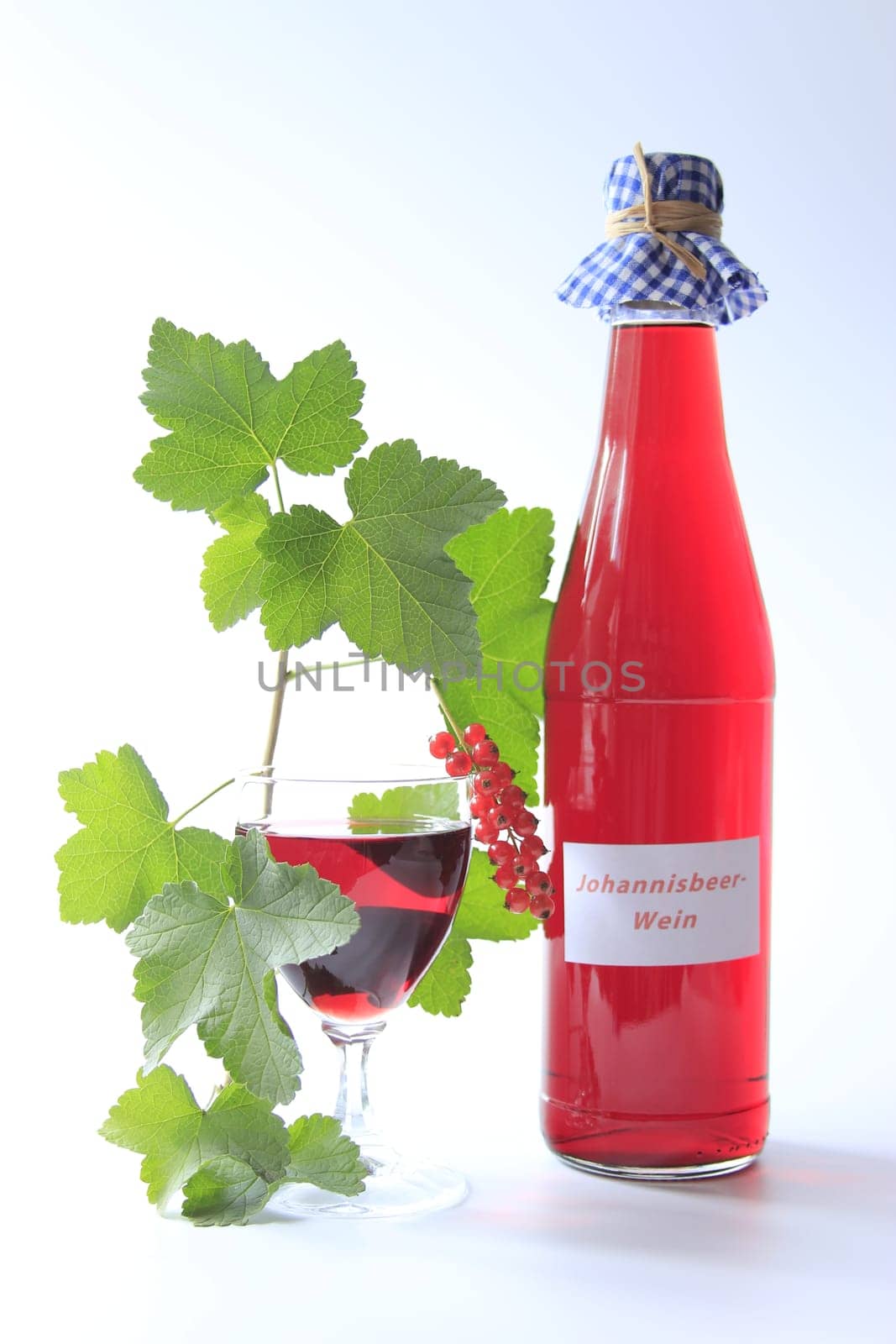 Red Currant Fruit Wine With Bottle And Glass Isolated Against Neutral Background