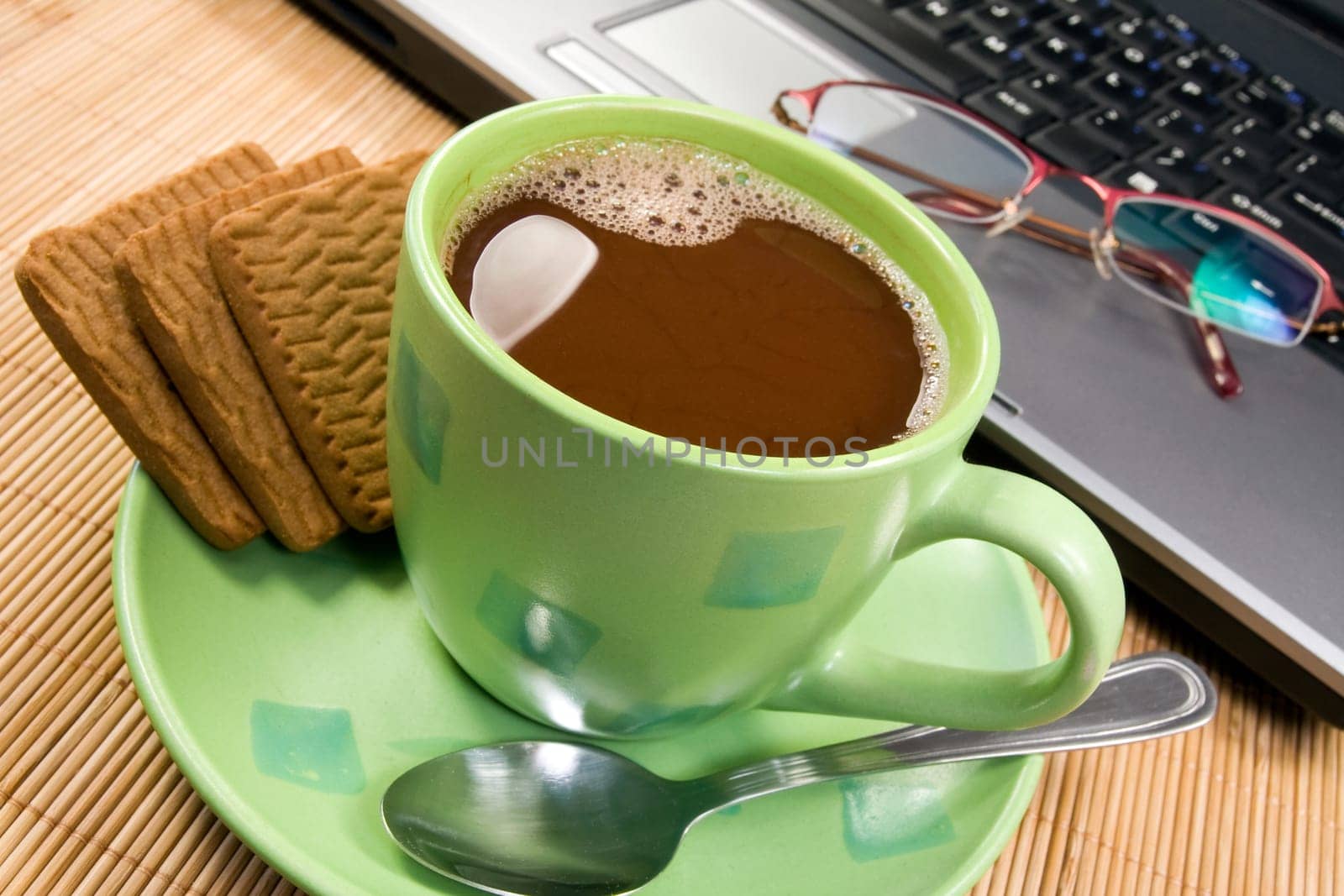 cup of hot cacao, biscuits and computer