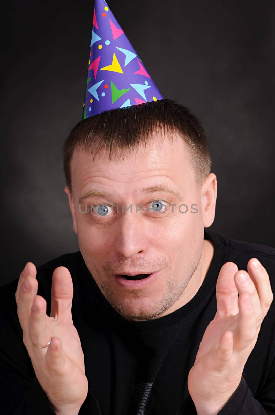surprised by the man in hat in the dark background