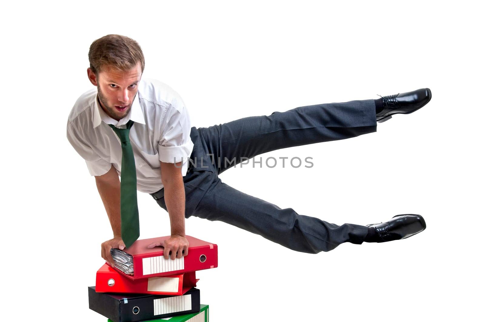 Businessman doing exercices over stack of files