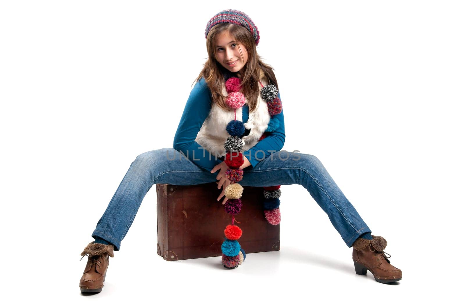 Beautiful young girl posing with case isolated in white
