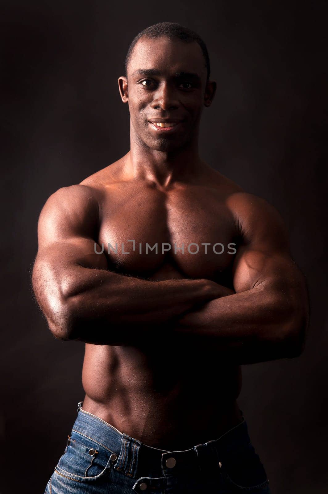 Beautiful and muscular black man in dark background