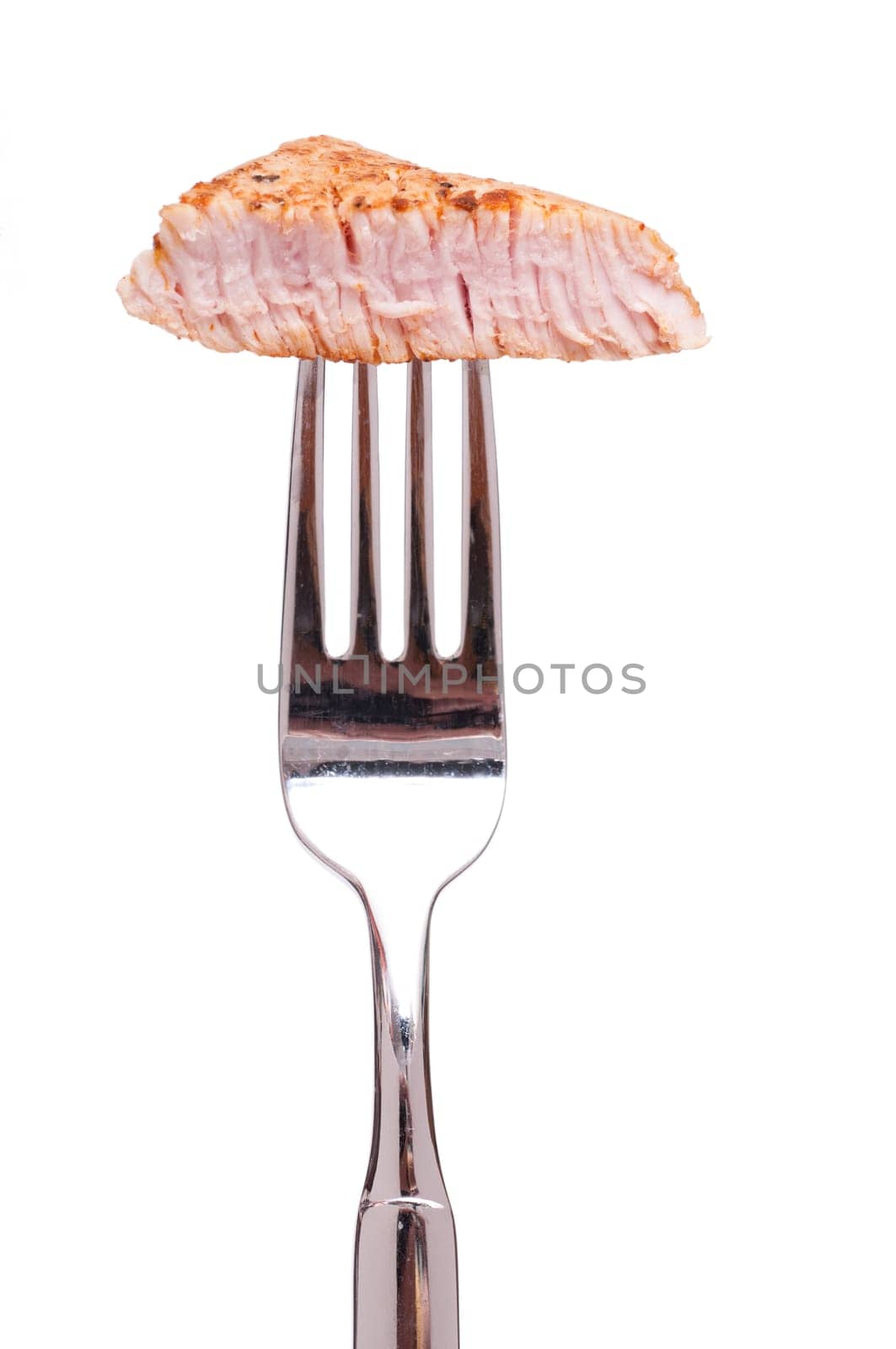 A piece of roasted veal on a fork white cut out