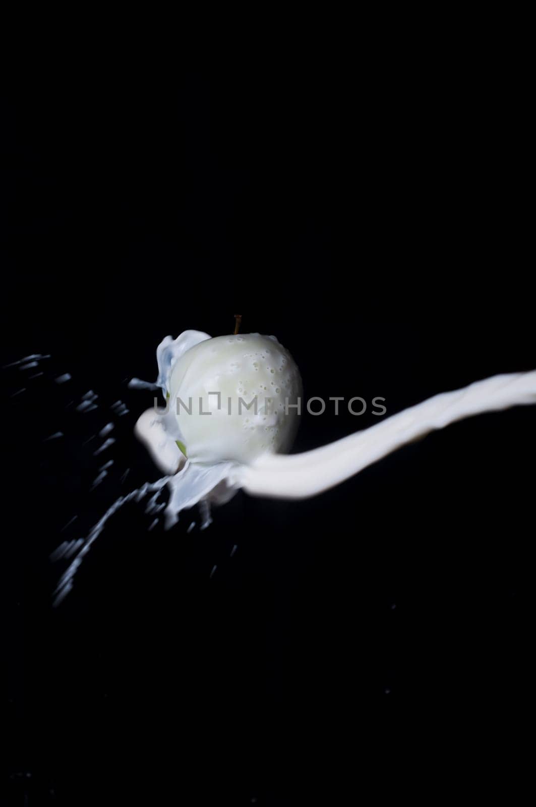 Shot of apple and splash on black background