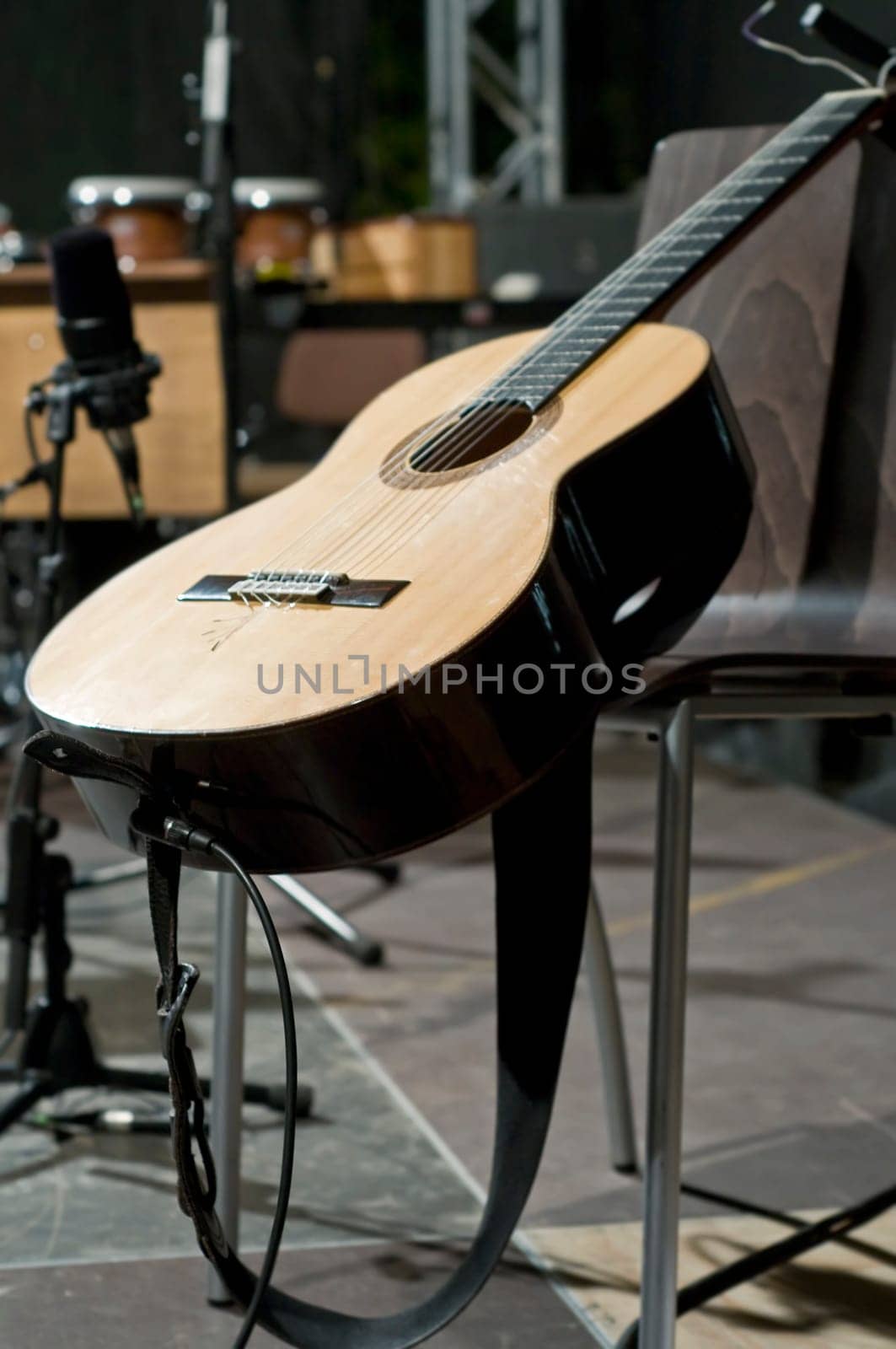 Single concert guitar on the stage waiting to be played