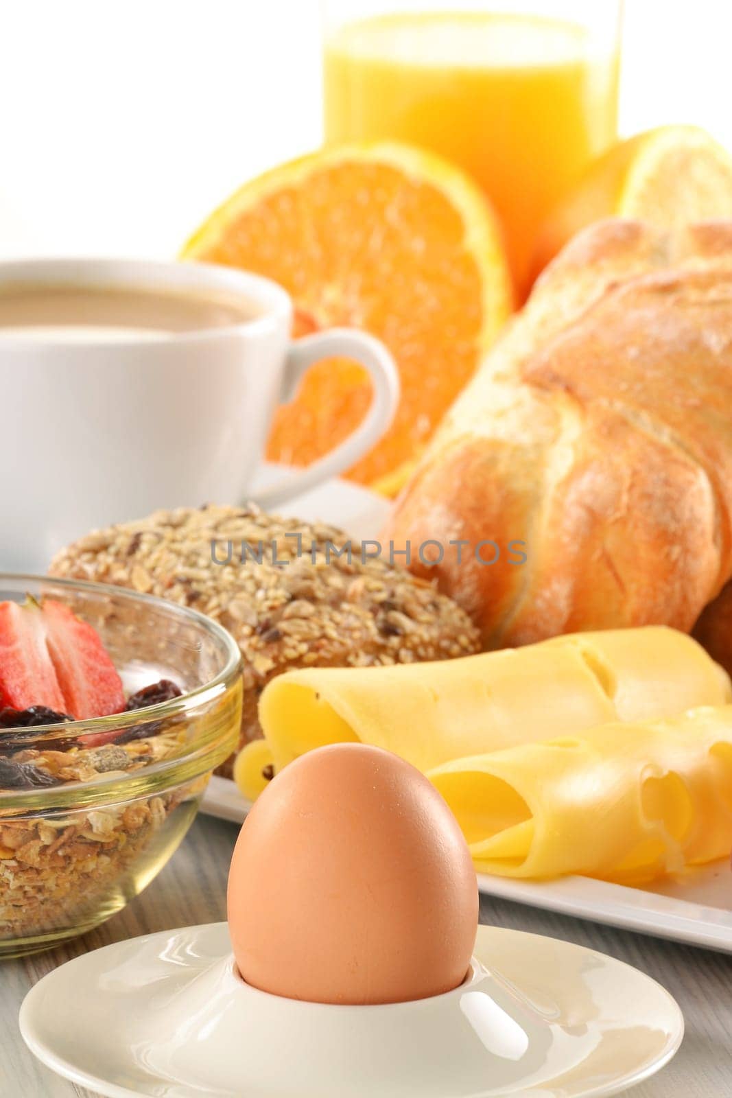 Breakfast with coffee, rolls, egg, orange juice, muesli and cheese