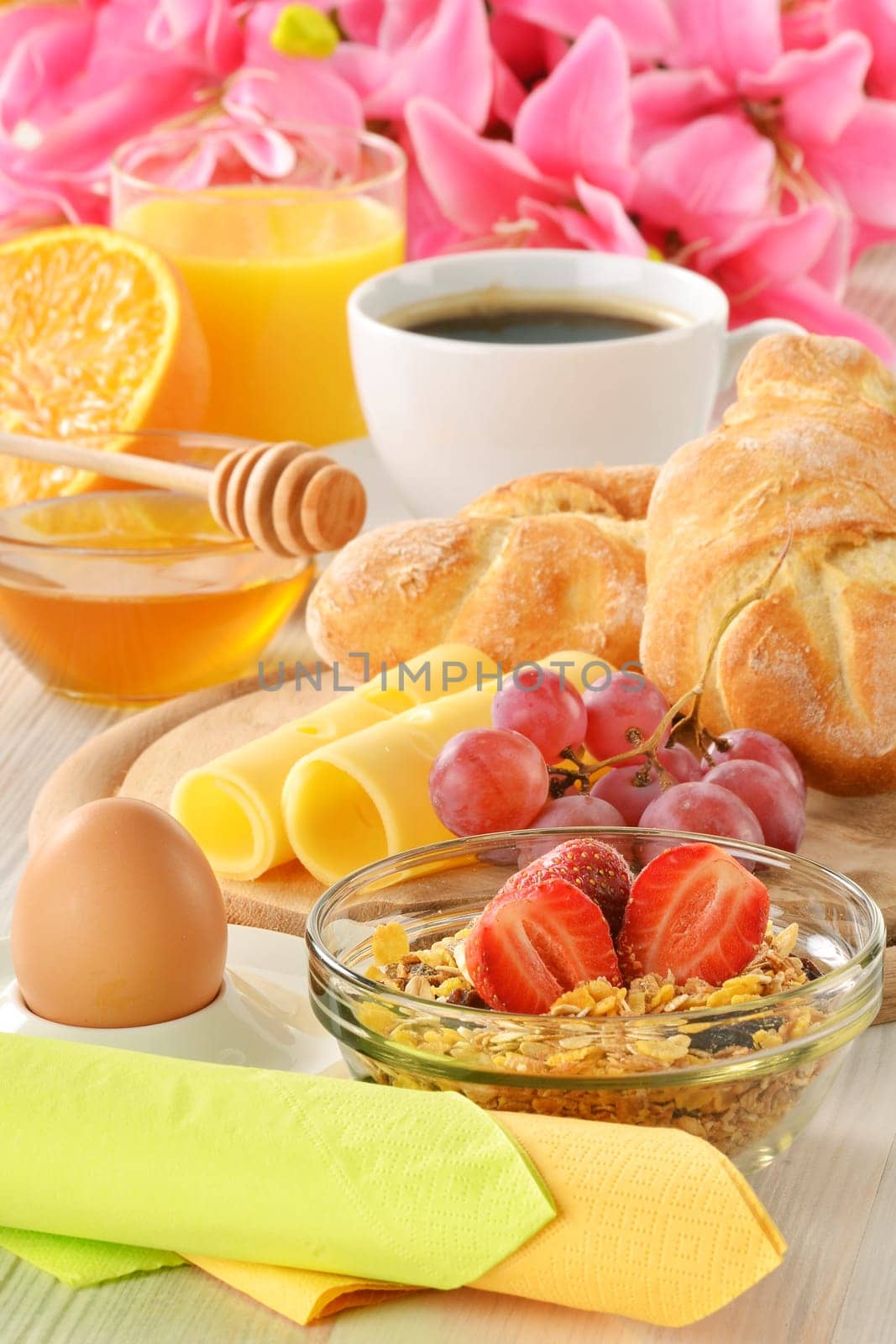 Breakfast with coffee, rolls, egg, orange juice, muesli and cheese