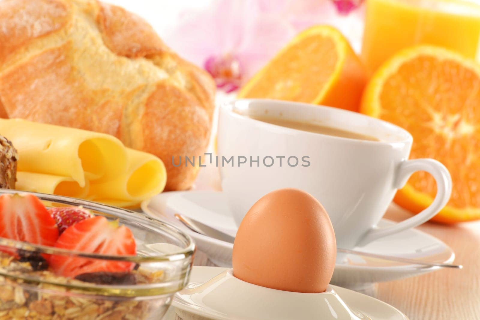 Breakfast with coffee, rolls, egg, orange juice, muesli and cheese