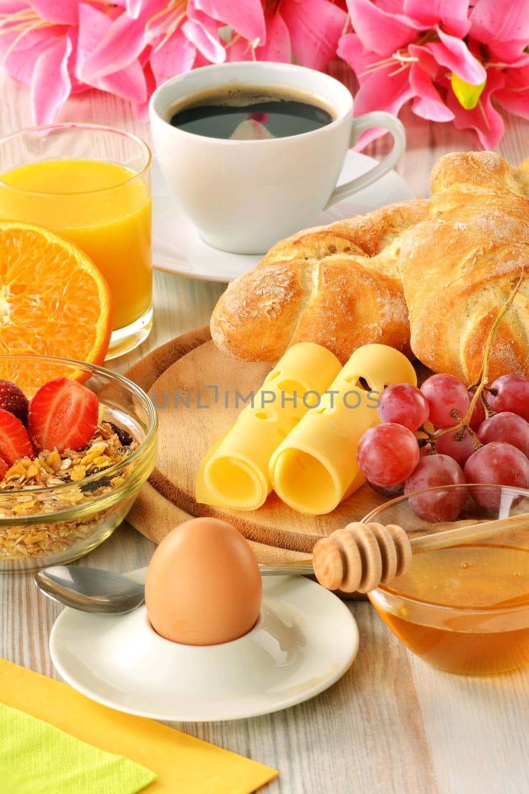 Breakfast with coffee, rolls, egg, orange juice, muesli and cheese