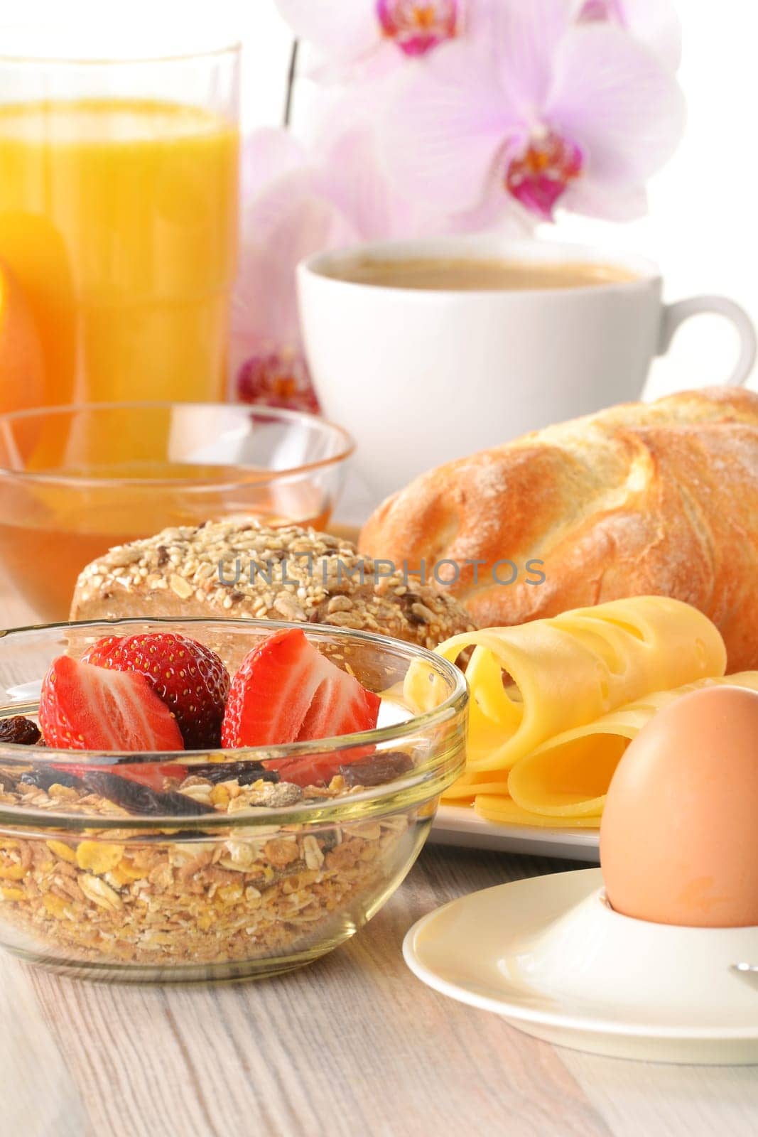 Breakfast with coffee, rolls, egg, orange juice, muesli and cheese