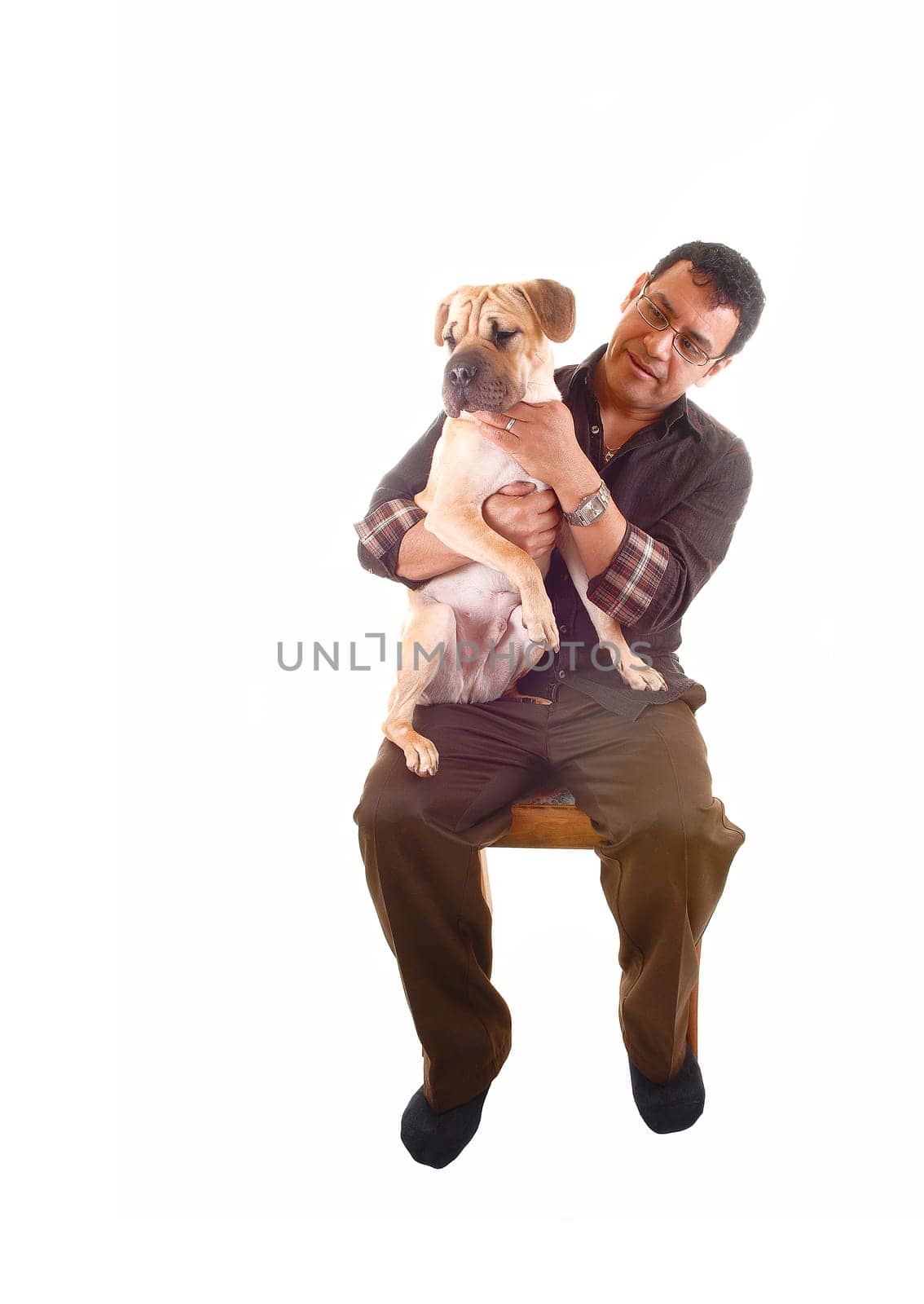 A Hispanic man in brown clothing sitting on a chair with his best friend on his lap, a sharpei puppy, for white background.