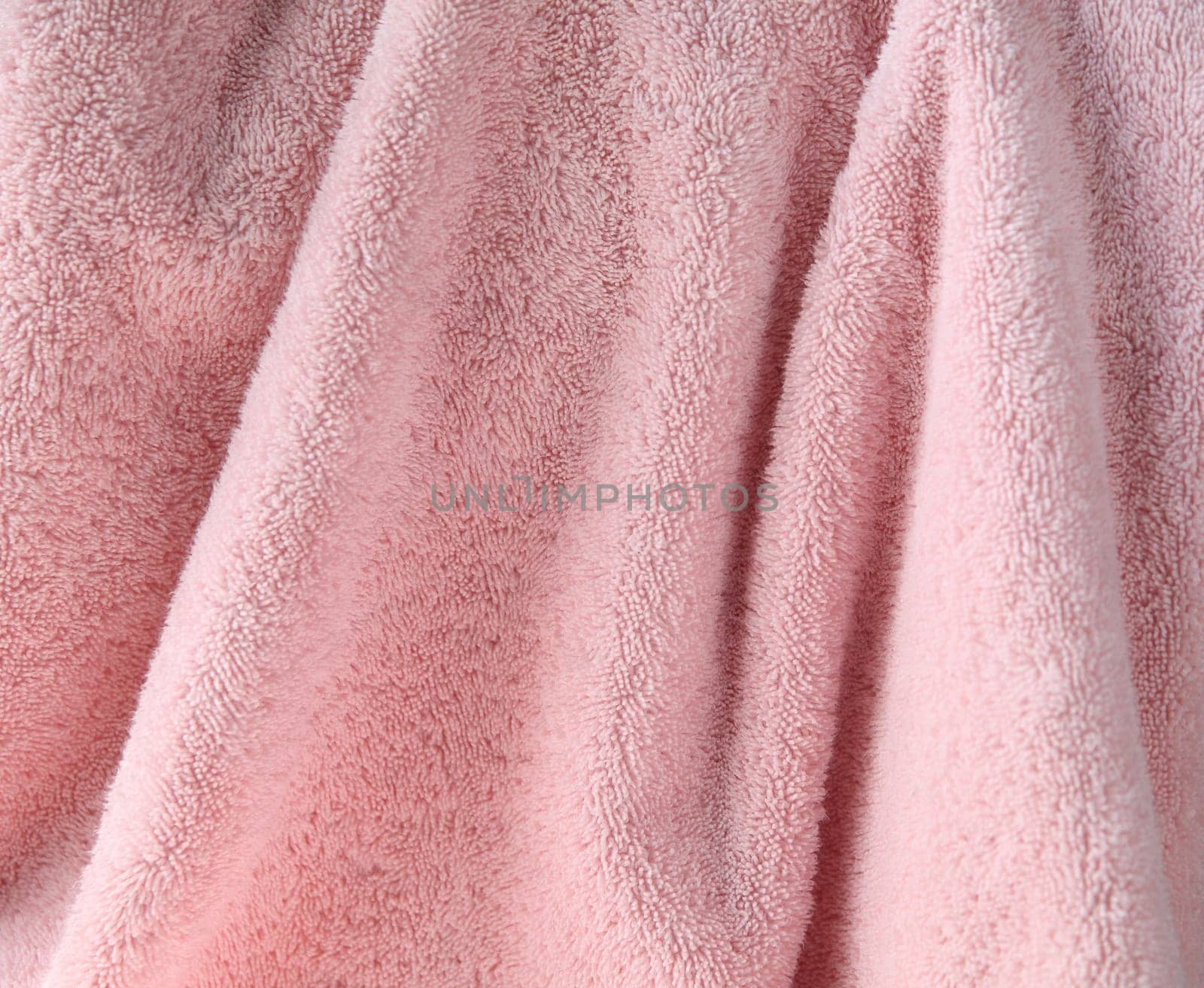 a large pale pink bath towel close up