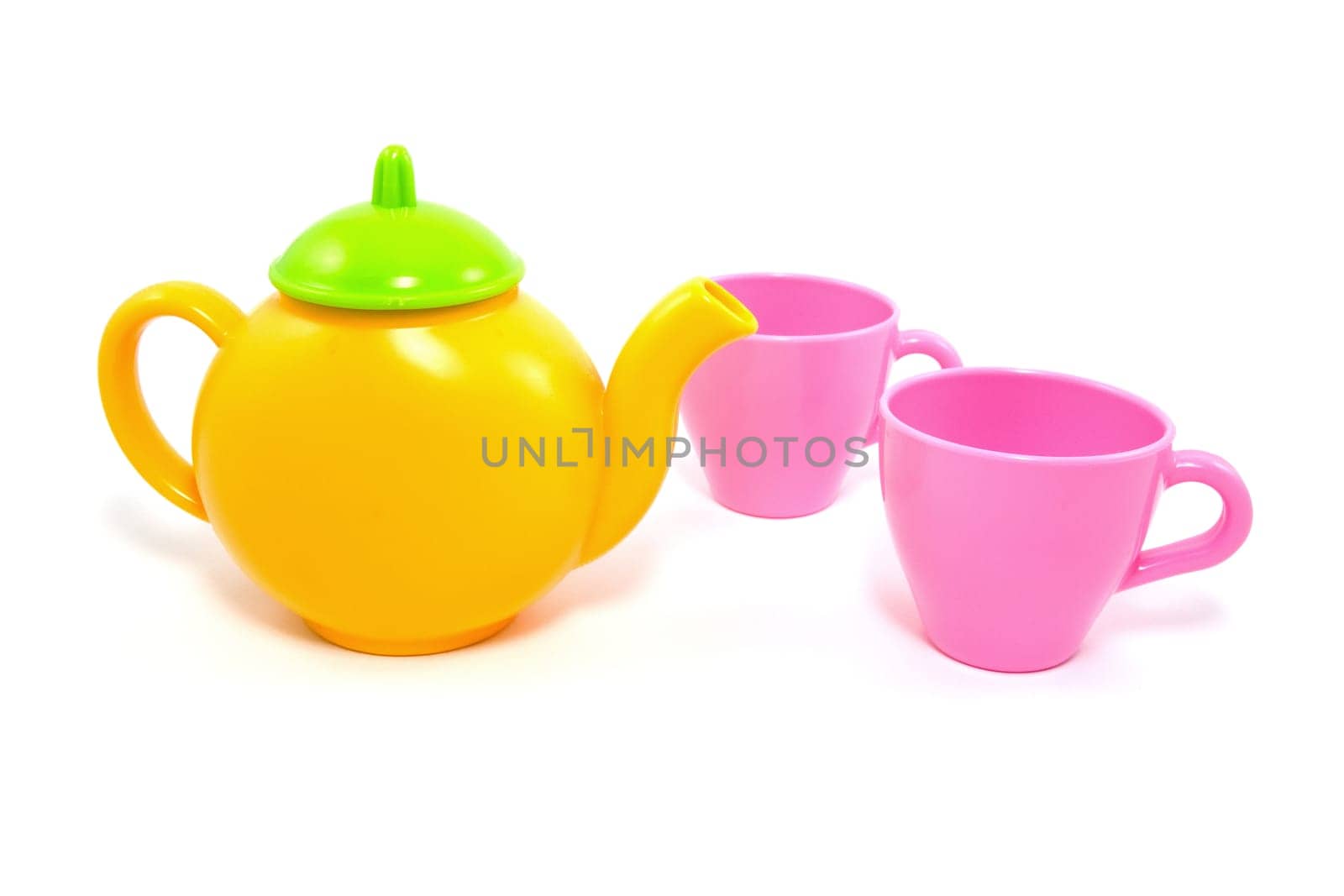 colorful teapot and cups over a white background