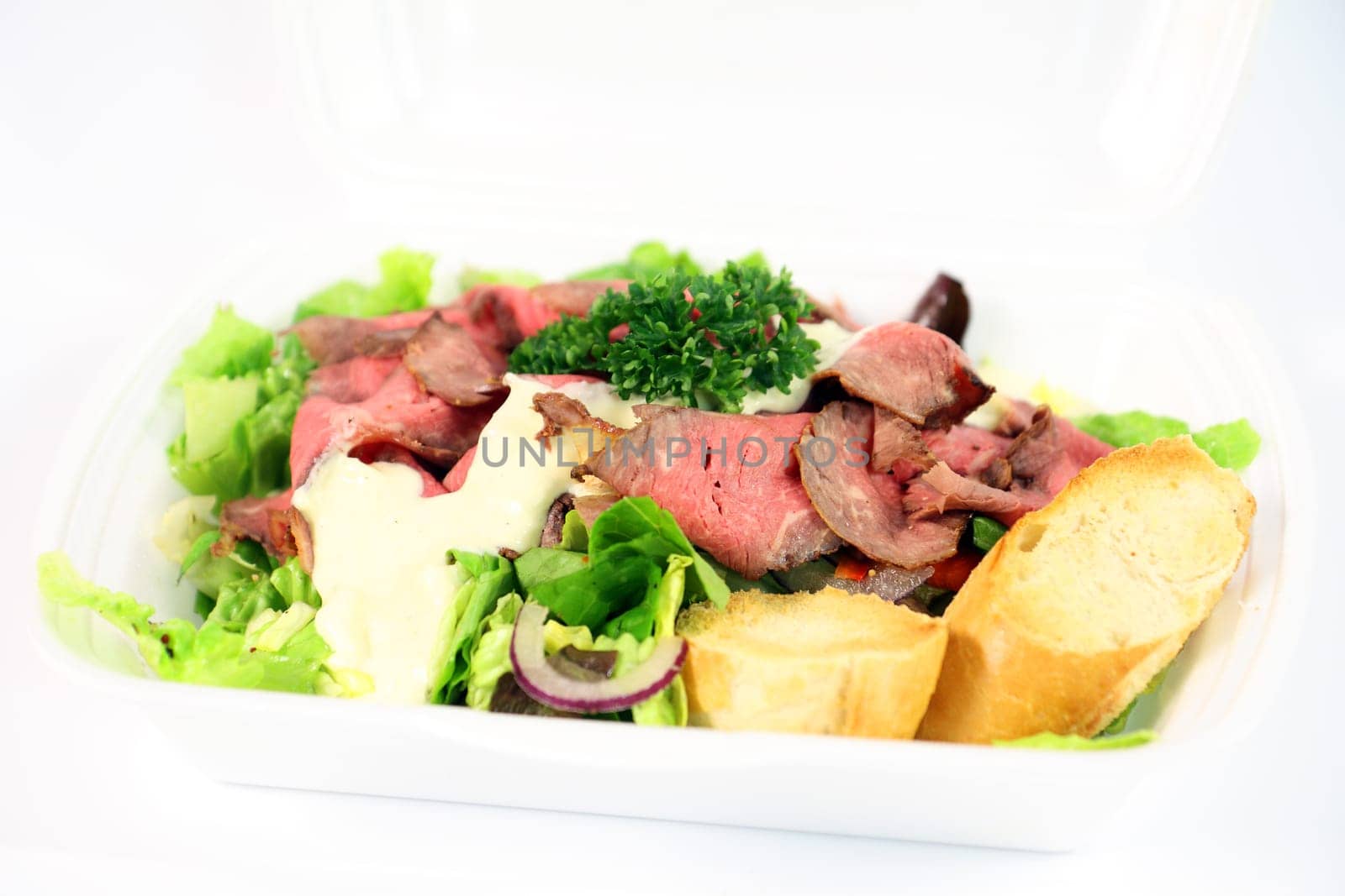 Roastbeef with fresh vegetable salad on white background