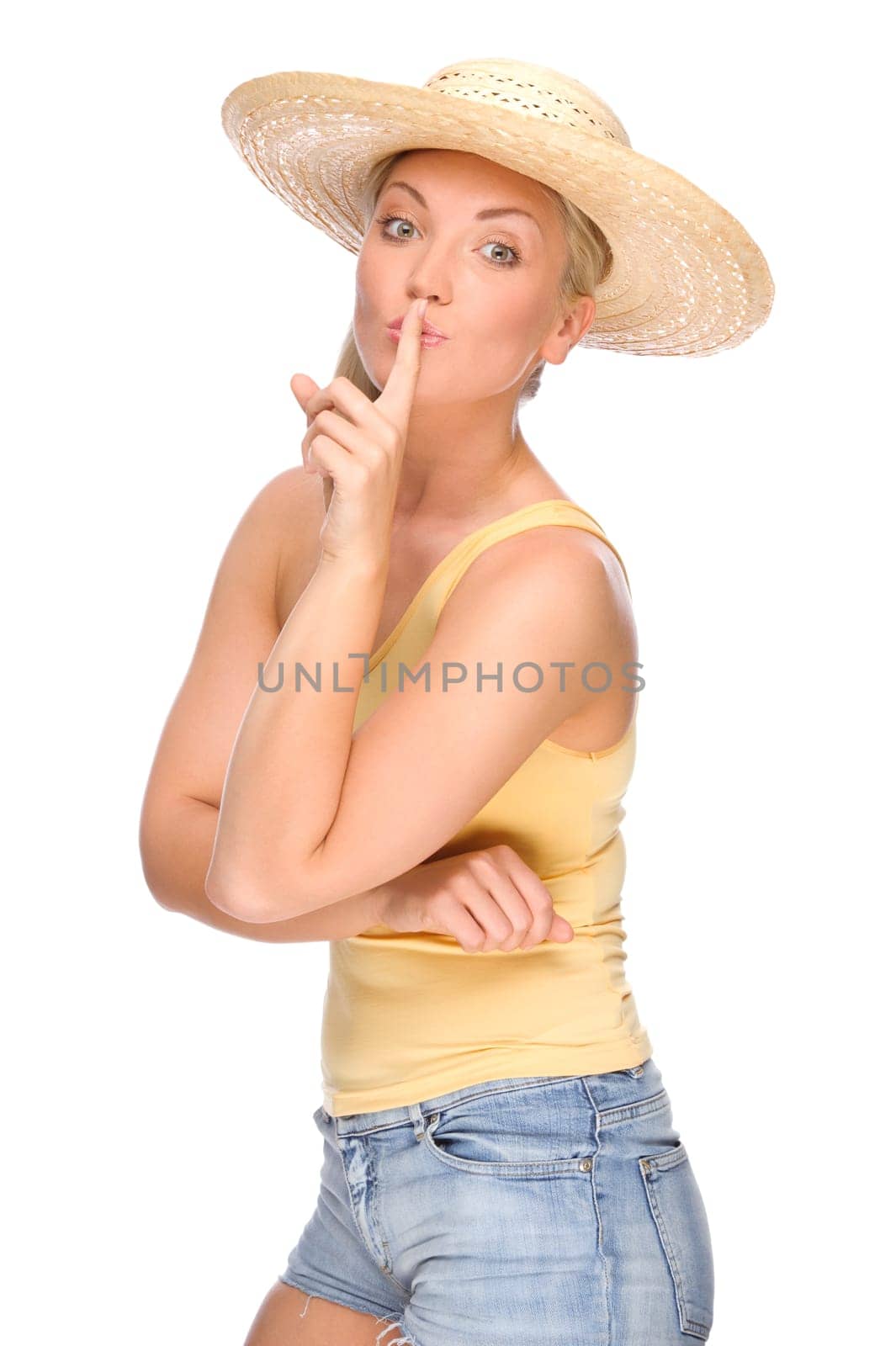 Studio shot of a young woman in a straw hat