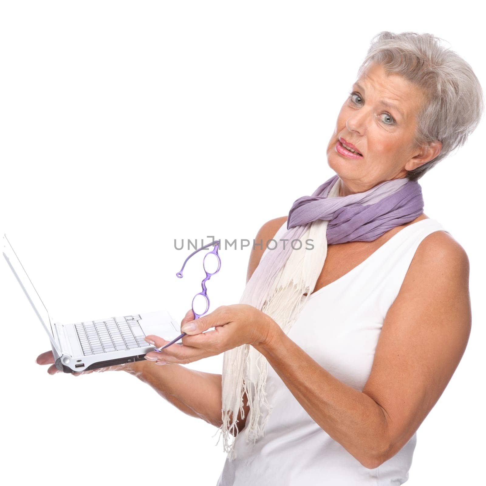 Studio shot of an active senior woman using a notebook