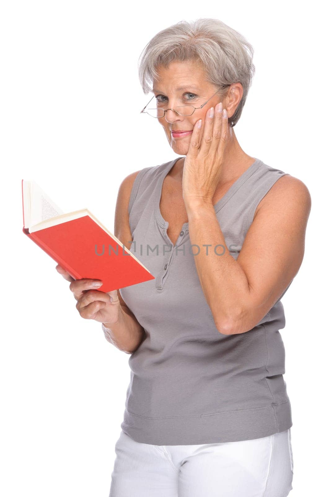 Studio shot of an active senior woman with a book