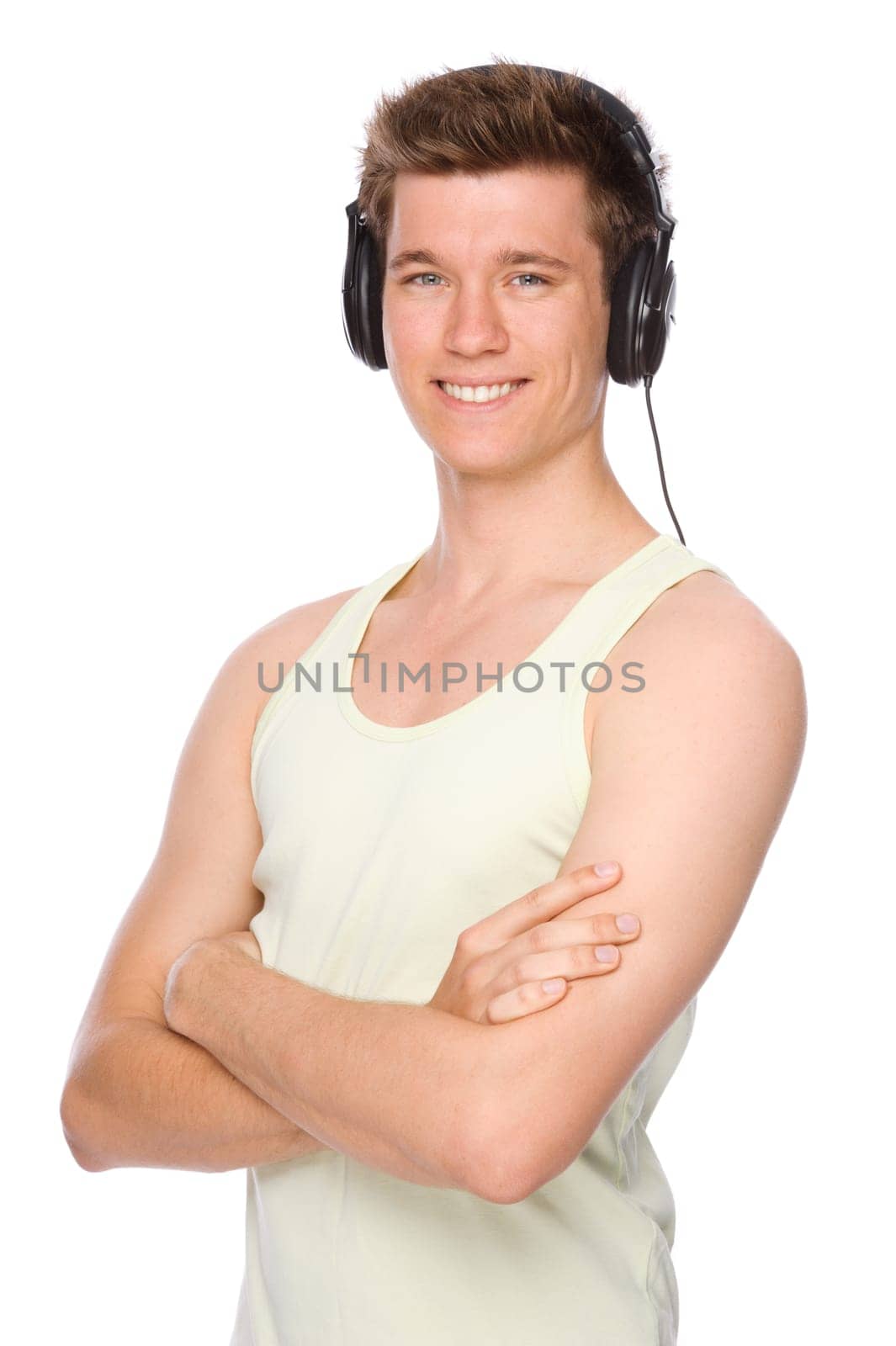 Studio shot of a young and happy man wearing headphones