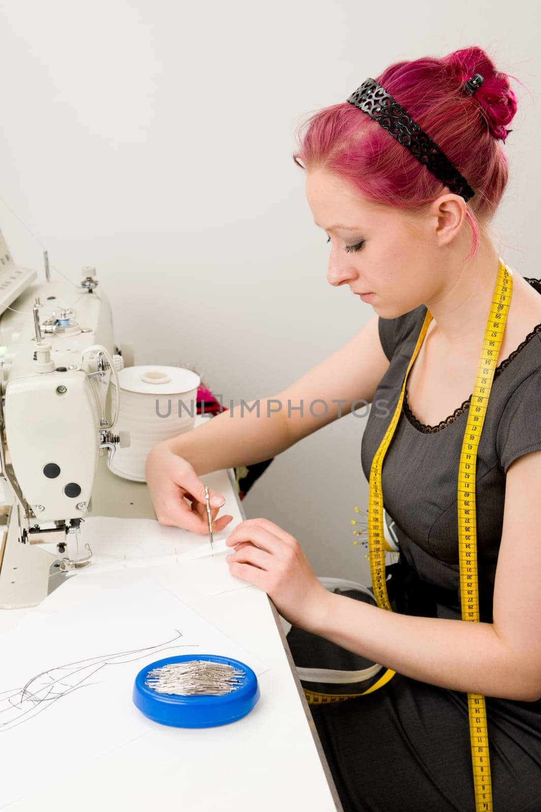 Young seamstress working on a sewing machine