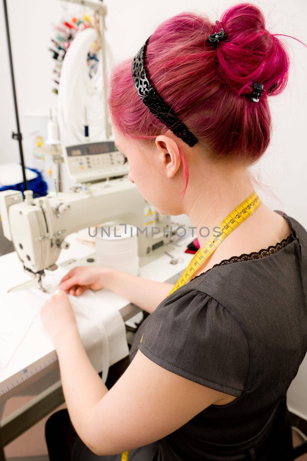 Young seamstress working on a sewing machine