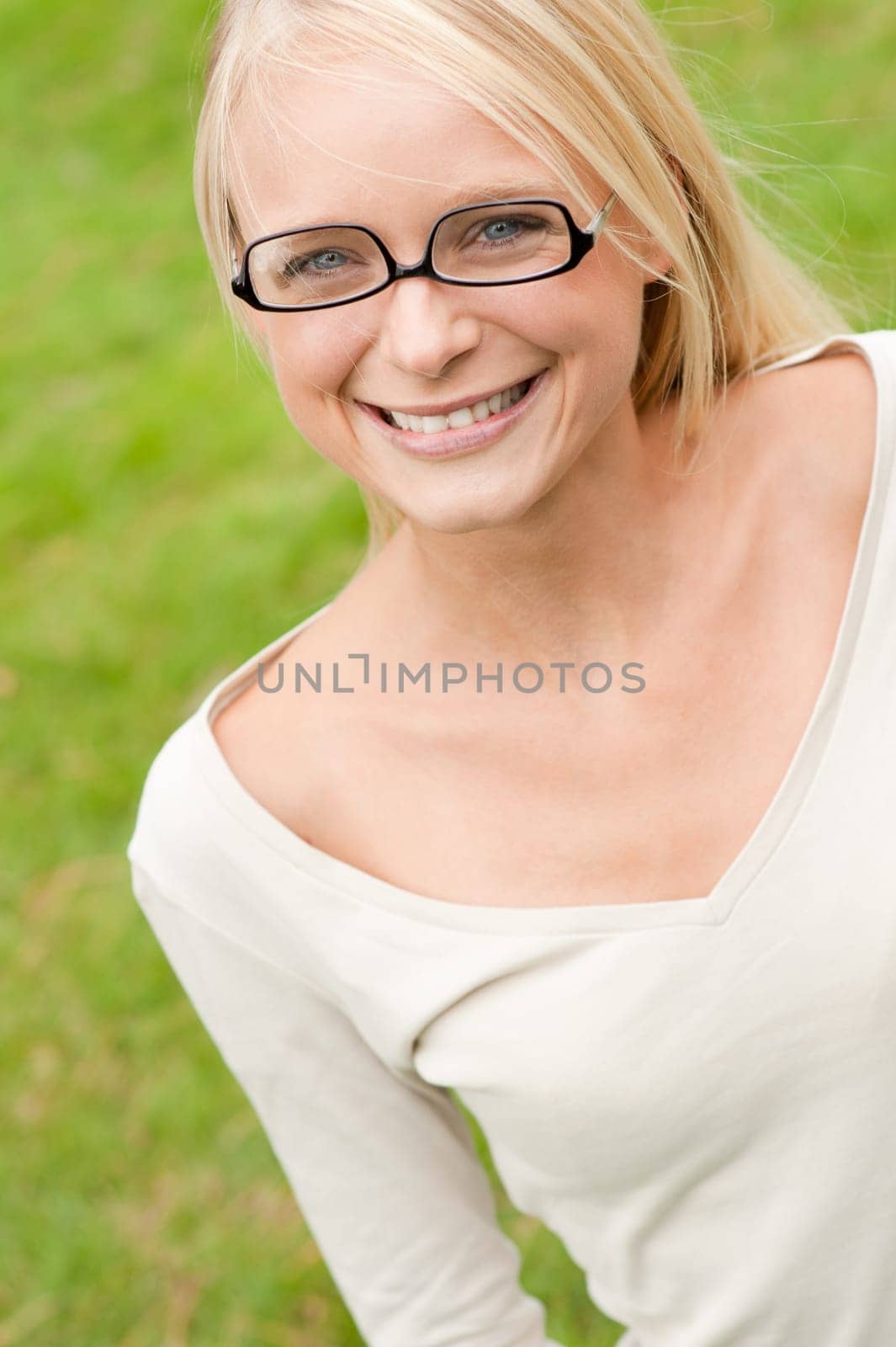 Portrait of a young and smiling woman in the park