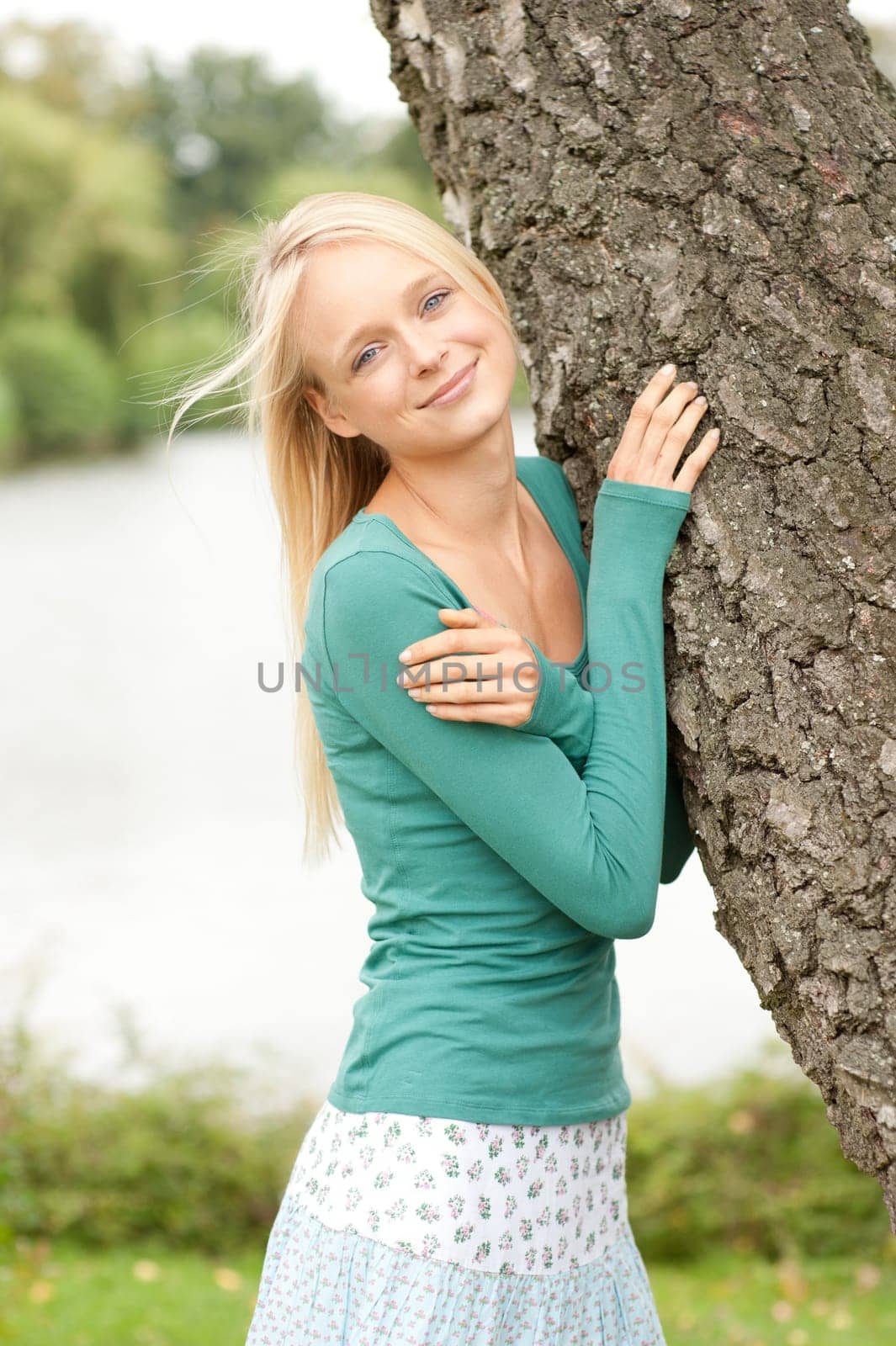 Portrait of a young and smiling woman in the park