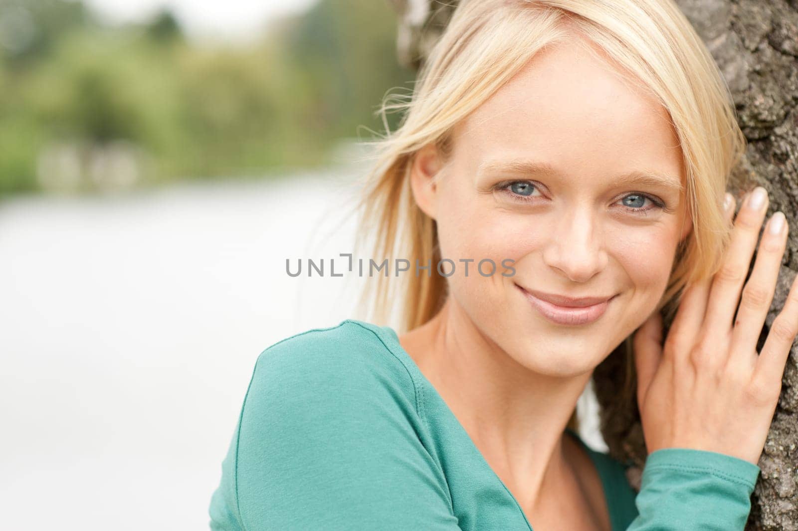 Portrait of a young and smiling woman in the park