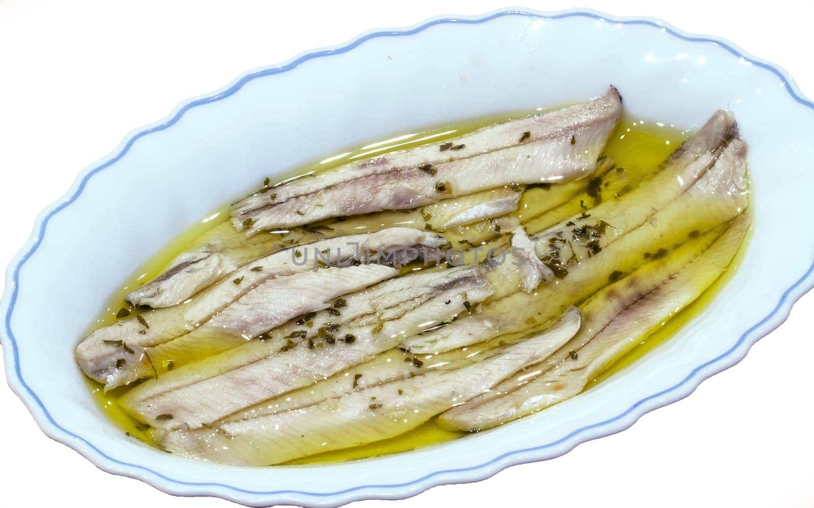 a pile of anchovies in vinegar isolated on a white background