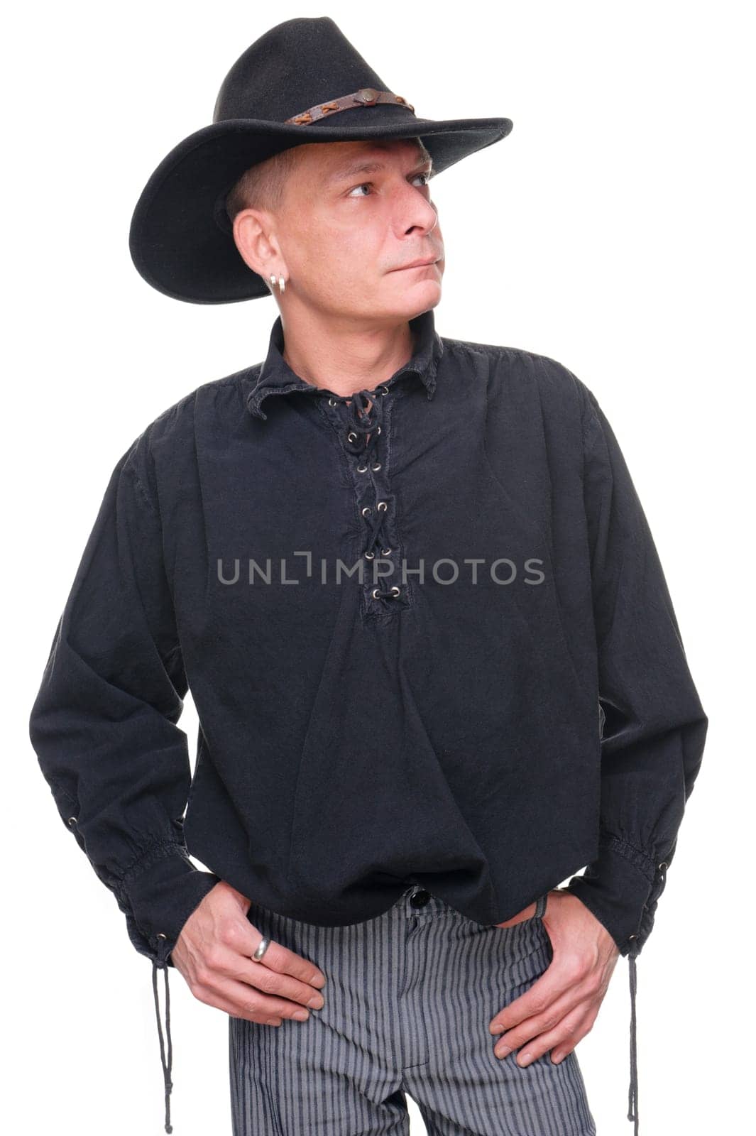 Man in western outfit against white background in studio