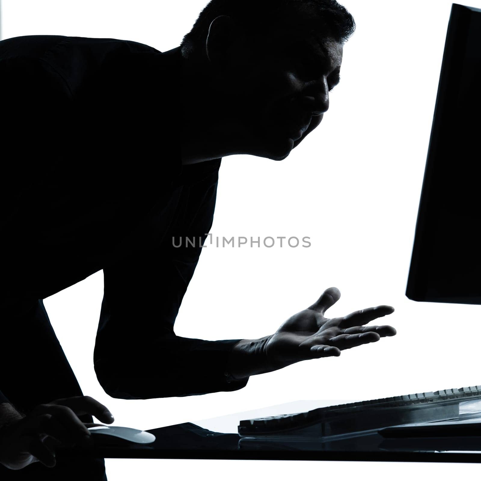 one caucasian business man computing computer angry displeased portrait silhouette in studio isolated on white background